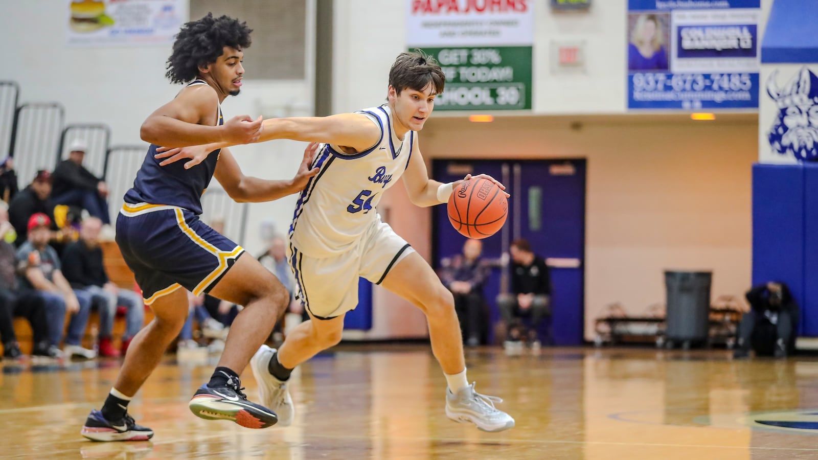 Miamisburg High School senior Andrew Hoerner drives past Springfield senior Zy'Aire Fletcher during their game on Friday night in Miamisburg. The Vikings won 54-44. CONTRIBUTED PHOTO BY MICHAEL COOPER