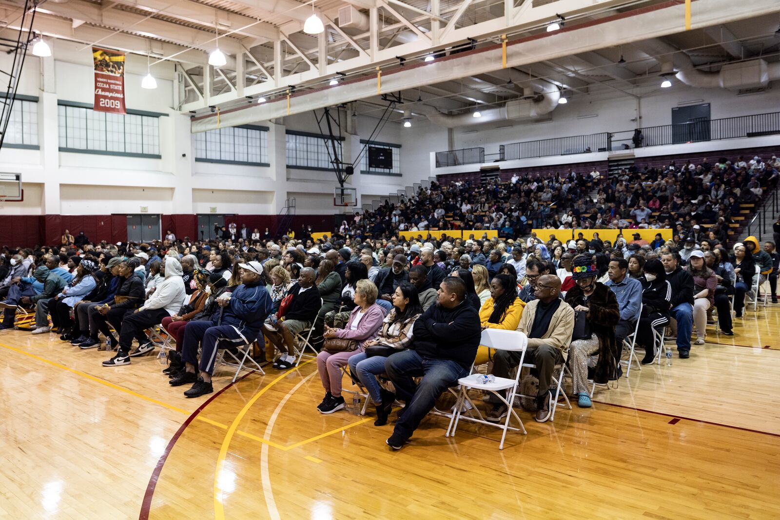 People impacted by the Eaton Fire attend an event at the gymnasium of Pasadena City College where The Change Reaction will be handing out about 1,000 checks of between $2,500-$5,000, Tuesday, Jan. 28, 2025 in Pasadena, Calif. (AP Photo/Etienne Laurent)