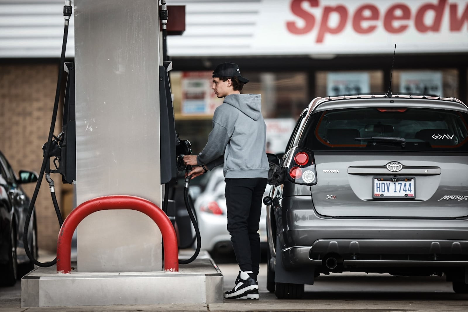 University of Dayton student Andrew Hornick pumps gas at the Speedway on East Stewart Street Thursday, April 6, 2023. Regular unleaded gasoline is $3.75 a gallon at both Speedway and UDF on the corner of Brown and East Stewart streets in Dayton. JIM NOELKER/STAFF