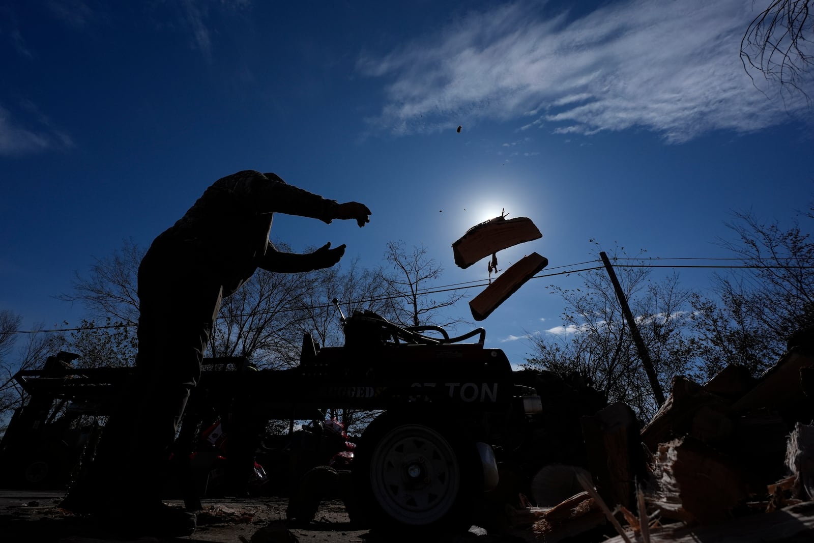 Sterling Howard tosses firewood to prepare for sale ahead of a winter storm expected to hit the North Texas region later tomorrow Wednesday, Jan. 8, 2025, in Dallas. (AP Photo/LM Otero)