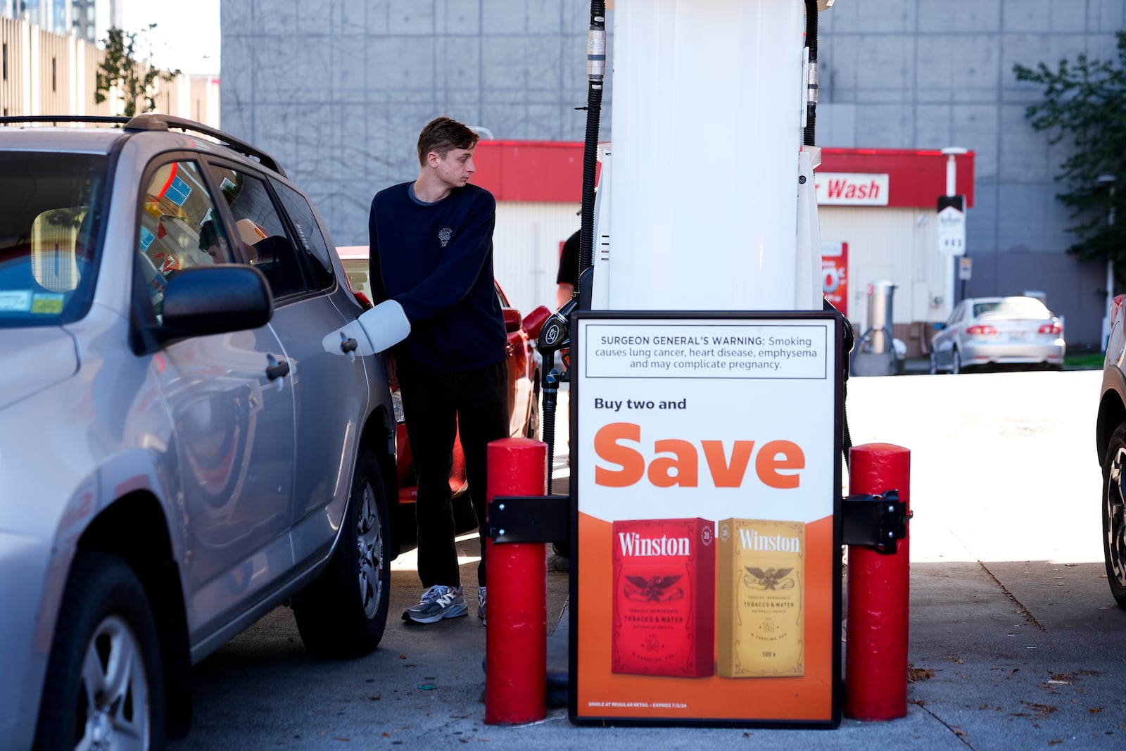 A driver fills up at a gasoline pump at a Shell gas station, Wednesday, Oct. 9, 2024, in Seattle. (AP Photo/Lindsey Wasson)