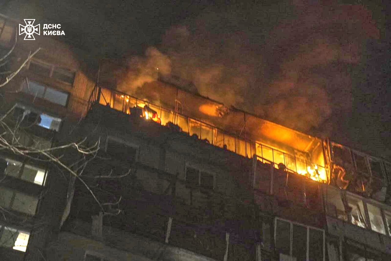 In this photo provided by the Ukrainian Emergency Service, firefighters put out the fire after a drone hit an apartment in a multi-storey building during Russia's drone attack in Kyiv, Ukraine, Sunday, March 23, 2025. (Ukrainian Emergency Service via AP)