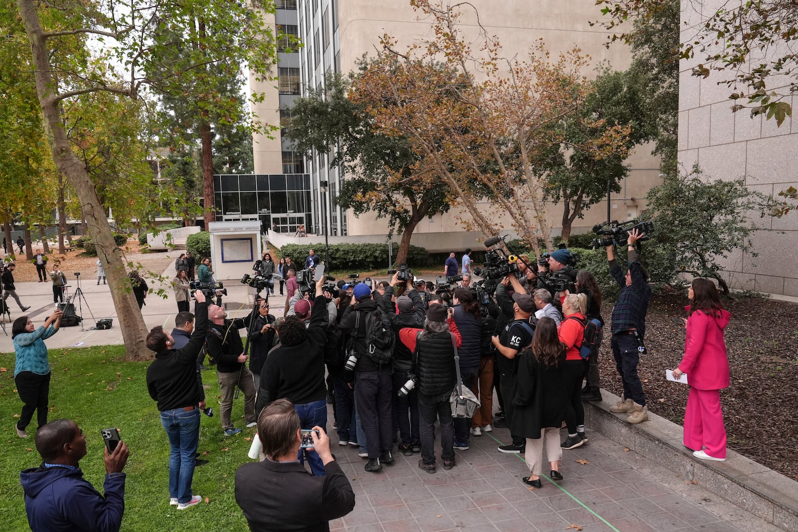 The media surround family members of Erik and Lyle Menendez brothers as they arrive at a courthouse to attend a hearing in Los Angeles, Monday, Nov. 25, 2024. (AP Photo/Jae C. Hong)