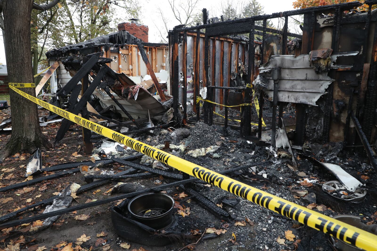 The remains of three apartments along South Harrison Street in Enon after they were destroyed by fire Sunday morning. BILL LACKEY/STAFF