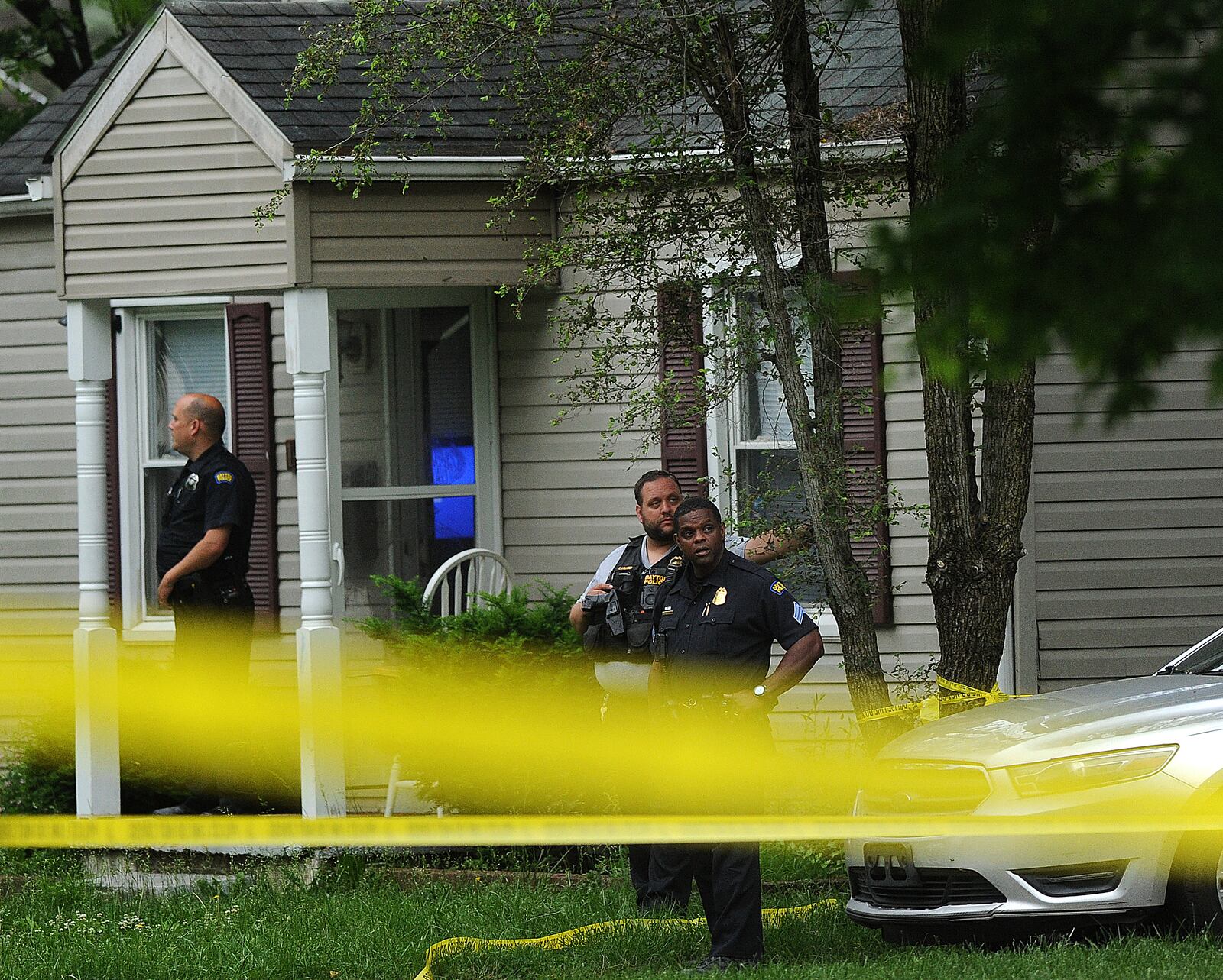 Members of the Dayton Police Department stand outside a house in the 1400 block of Shaftesbury Road early Wednesday morning, May 22, 2024. A woman and teen boy were killed after a shooting inside the home. MARSHALL GORBY\STAFF