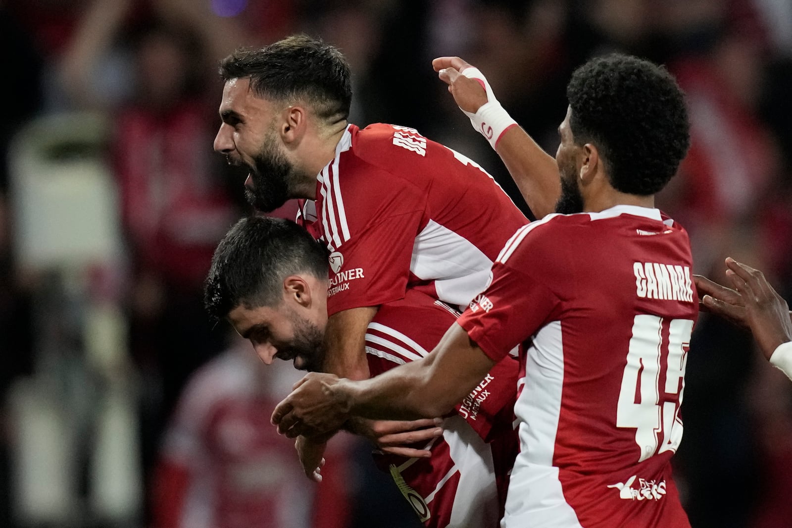 Brest players celebrate after a goal during the Champions League opening phase soccer match between Brest and Bayer Leverkusen in Guingamp, western France, Wednesday, Oct. 23, 2024. (AP Photo/Christophe Ena)