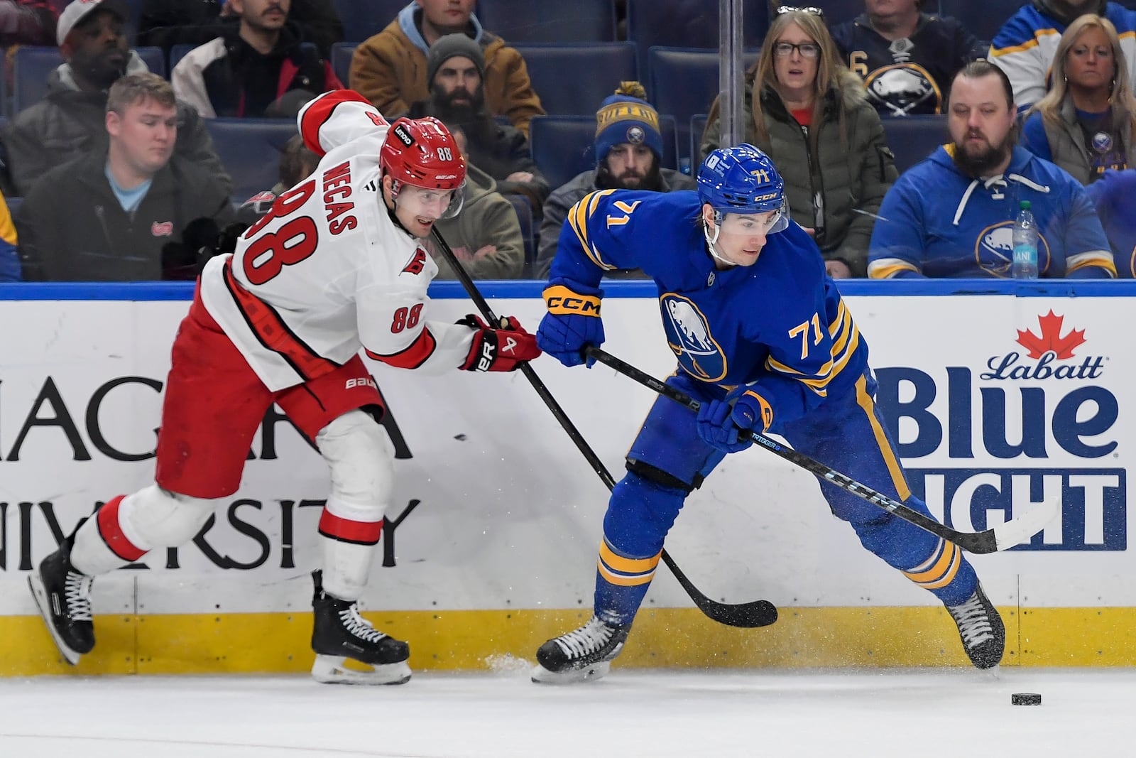 Buffalo Sabres center Ryan McLeod, right, controls the puck while pressured by Carolina Hurricanes center Martin Necas (88) during the third period of an NHL hockey game in Buffalo, N.Y., Wednesday, Jan. 15, 2025. Buffalo beat Carolina 4-2. (AP Photo/Adrian Kraus)