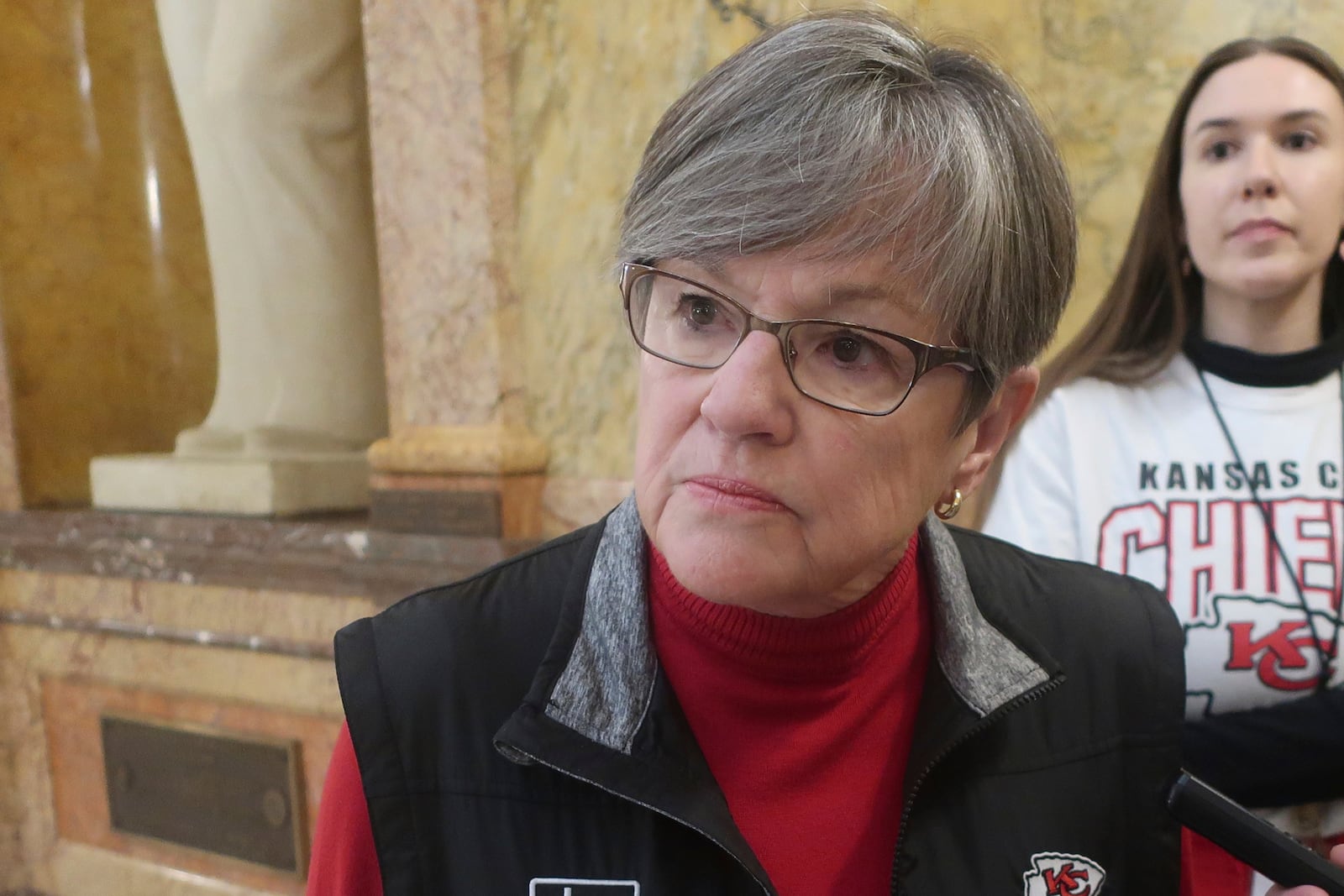 Kansas Gov. Laura Kelly speaks to reporters following a public event, Friday, Feb. 7, 2025, at the Statehouse in Topeka, Kansas. She has vetoed a bill that would ban gender-affirming care for transgender minors. (AP Photo/John Hanna)