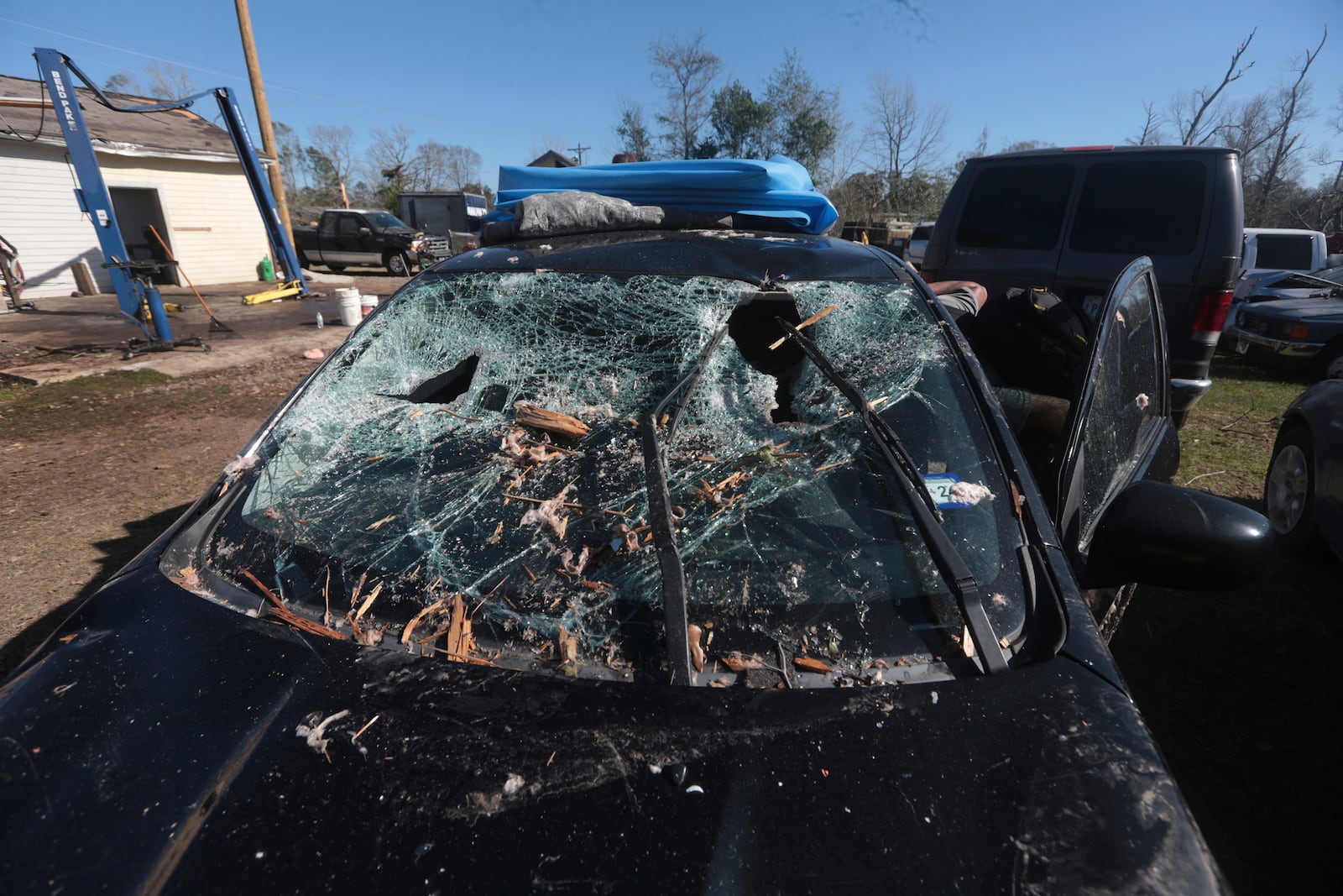 The windshield of a car in Conroe, Texas, is left smashed on Monday, Dec. 30, 2024, following a strong weekend storm system that spawned hail, rain, high winds and tornadoes across the southern U.S. (AP Photo/Lekan Oyekanmi)