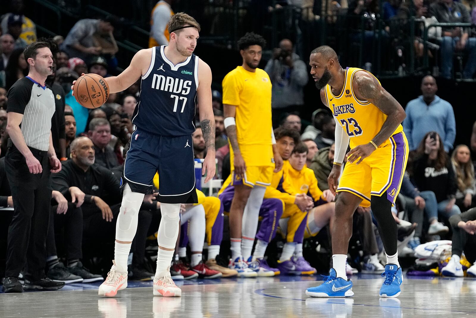 FILE - Dallas Mavericks guard Luka Doncic (77) dribbles against Los Angeles Lakers forward LeBron James (23) during the second half of an NBA basketball game in Dallas, Dec. 12, 2023. (AP Photo/LM Otero, File)