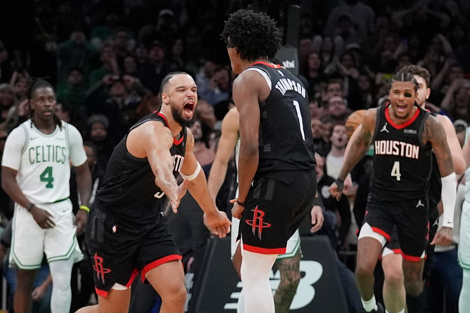 Houston Rockets forward Amen Thompson (1) is congratulated by Dillon Brooks, front left, after making the winning basket against the Boston Celtics in the final seconds of an NBA basketball game, Monday, Jan. 27, 2025, in Boston. (AP Photo/Charles Krupa)