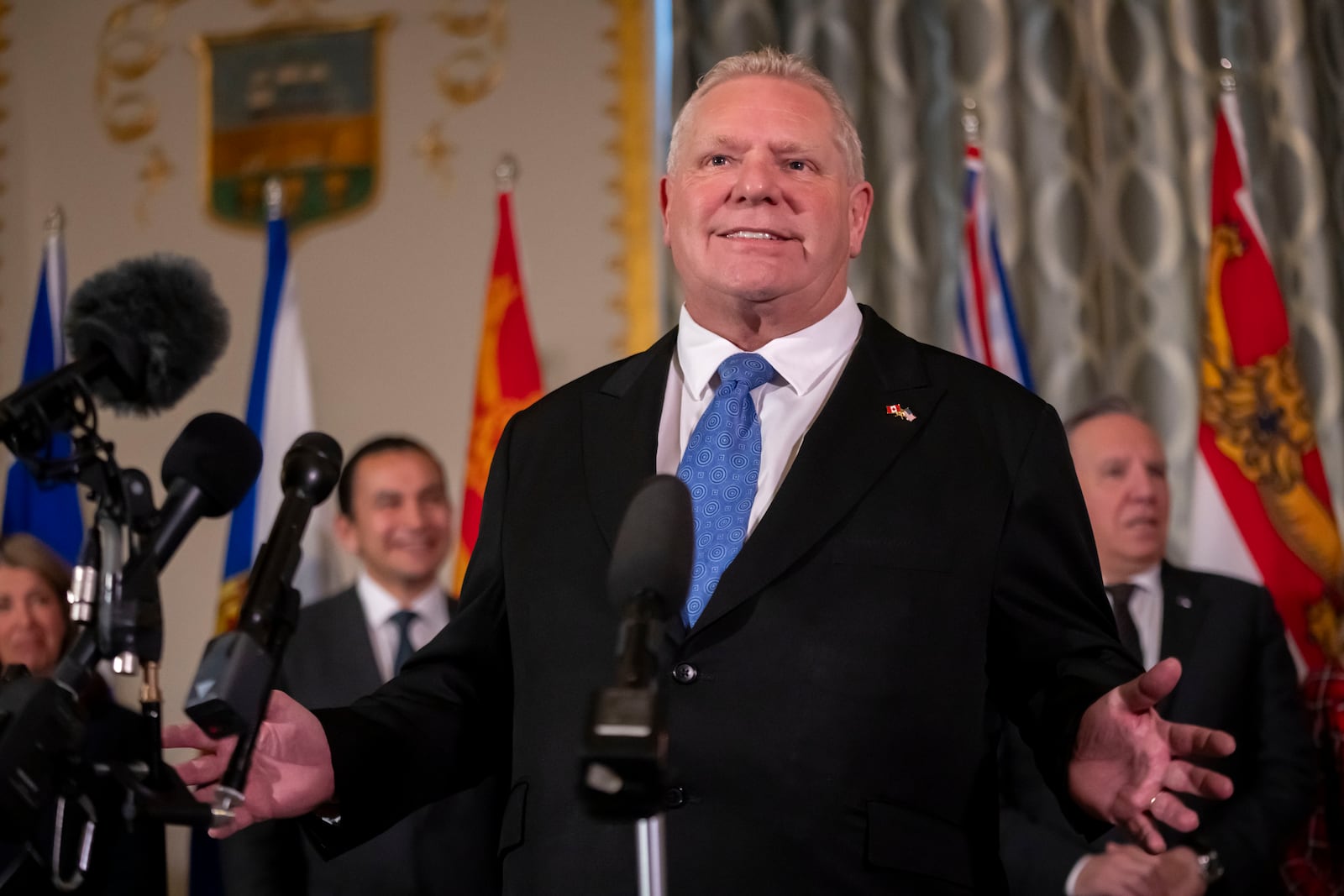 Premier of Ontario Doug Ford speaks to reporters, accompanied by other Council of the Federation members, at the Mayflower Hotel in Washington, Wednesday, Feb. 12, 2025. (AP Photo/Ben Curtis)