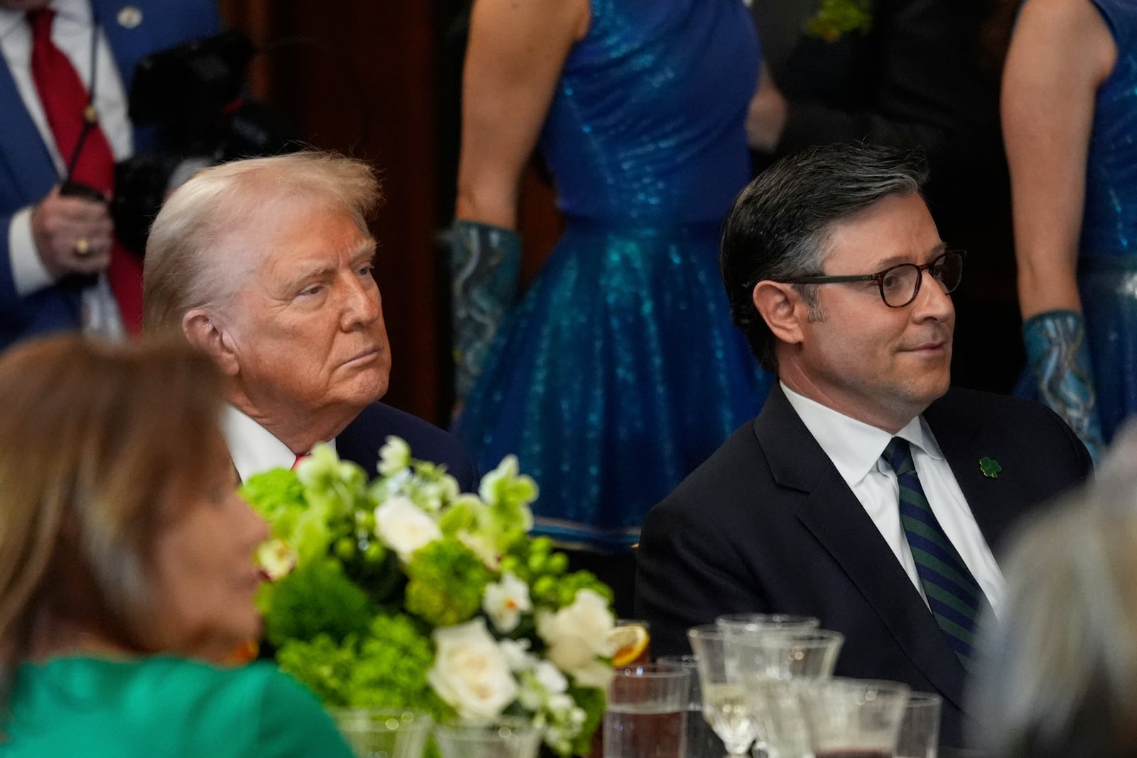 President Donald Trump and House Speaker Mike Johnson of La., listen at the annual St. Patrick's Day luncheon at the Capitol in Washington, Wednesday, March 12, 2025. (AP Photo/J. Scott Applewhite)