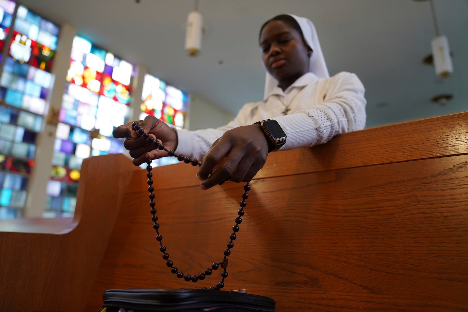 Sister Seyram Mary Adzokpa prays the rosary in the chapel at the motherhouse of the Sisters of the Holy Family in New Orleans, Wednesday, June 26, 2024. (AP Photo/Jessie Wardarski)