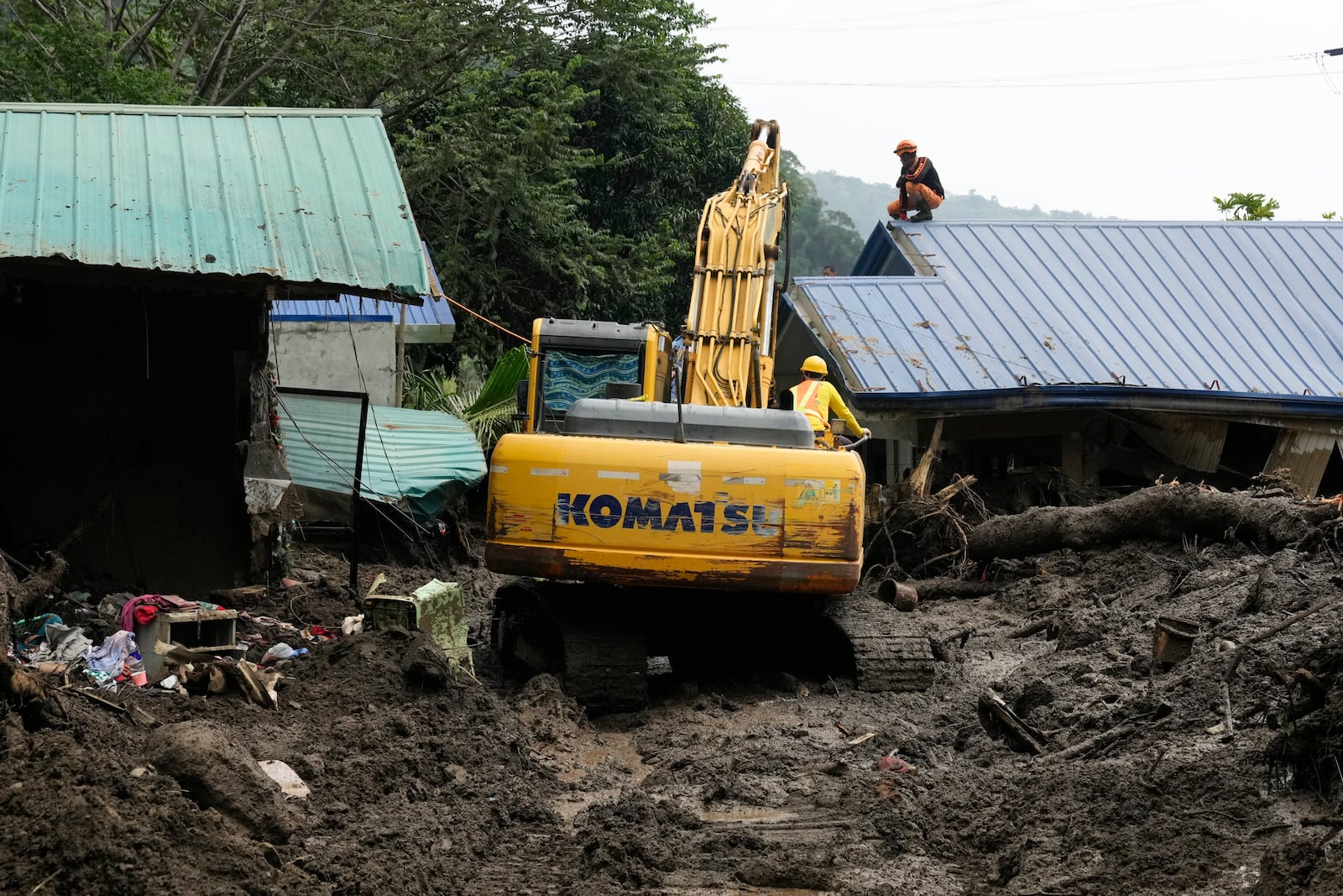 Rescuers work at the site after a recent landslide triggered by Tropical Storm Trami struck Talisay, Batangas province, Philippines leaving thousands homeless and several villagers dead on Saturday, Oct. 26, 2024. (AP Photo/Aaron Favila)