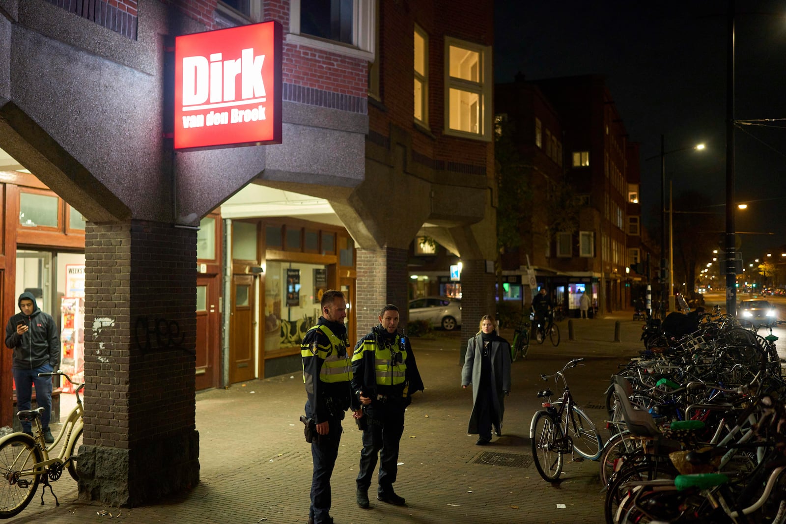 Police officers are seen patrolling the streets in Amsterdam, Netherlands, Tuesday, Nov. 12, 2024, as the city is facing tensions following violence last week. (AP Photo/Bram Janssen)