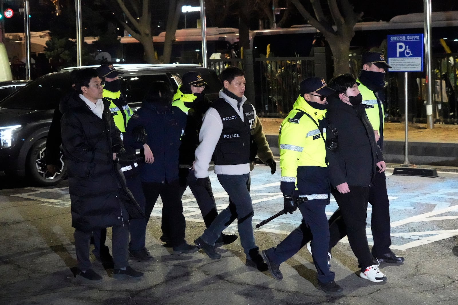 Police officers detain supporters of impeached South Korean President Yoon Suk Yeol after they illegally climbed over a fence inside the Seoul Western District Court in Seoul, South Korea, Saturday, Jan. 18, 2025. (AP Photo/Ahn Young-joon)