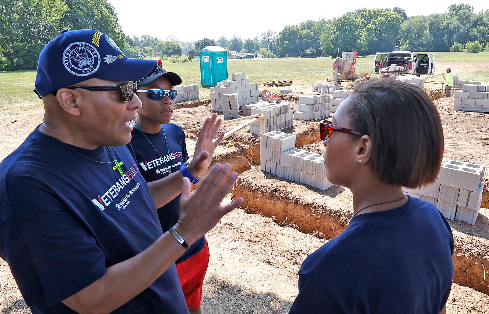 Navy Veteran Len Pringle describes to his children Benjamin and Gabby what their future house will look like before a ground breaking ceremony Friday, August 4, 2023 at 608 W. Madison Street in New Carlisle. Habitat for Humanity is helping the Pringle family with building the house and getting a 0% home mortgage through a program called VeteransBuild. BILL LACKEY/STAFF