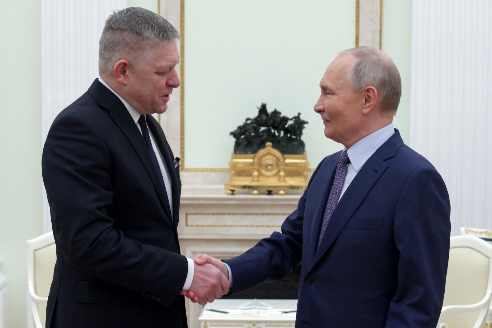 Russian President Vladimir Putin, right, and Slovak Prime Minister Robert Fico greet each other during their meeting at the Kremlin in Moscow, Russia, Sunday, Dec. 22, 2024. (Gavriil Grigorov, Sputnik, Government Pool Photo via AP)