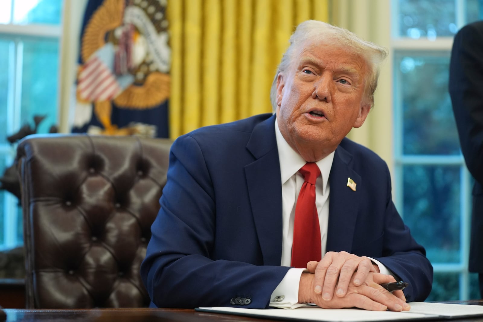 President Donald Trump speaks before signing an executive order in the Oval Office of the White House, Monday, Feb. 3, 2025, in Washington. (AP Photo/Evan Vucci)