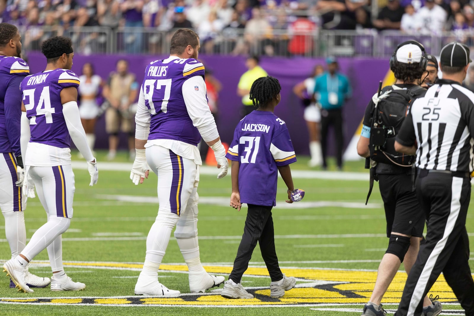 FILE - Former Minnesota Vikings rookie Khyree Jackson's brother Kolston Jackson (31) walks on the field for the coin toss with Minnesota Vikings defensive tackle Harrison Phillips (97) before an NFL preseason football game against the Las Vegas Raiders, Saturday, Aug. 10, 2024, in Minneapolis. (AP Photo/Andy Clayton-King, File)