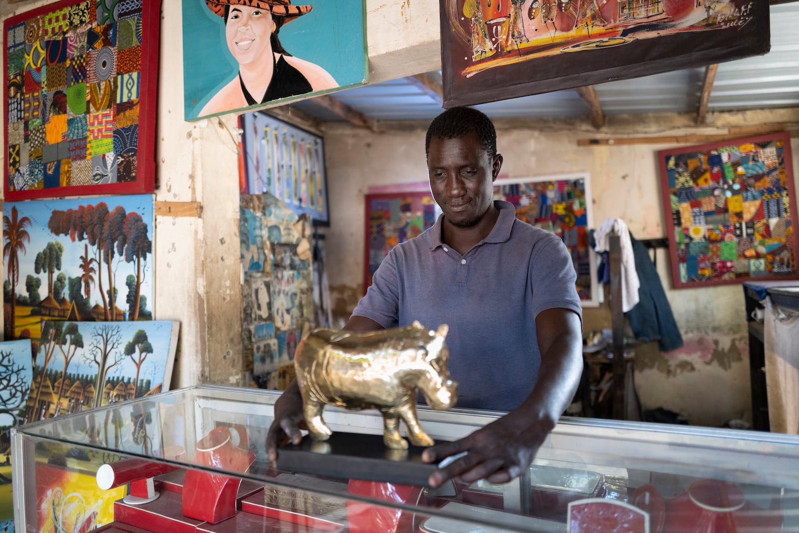 Jeweller Moussa Diop presents a bronze hippopotamus in his workshop, as part of the rebondir exhibition at the Dakar 2024 biennial Off in Dakar, Senegal, Thursday, Nov. 28, 2024. (AP Photo/Sylvain Cherkaoui)