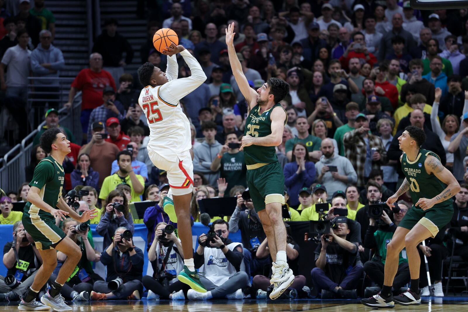 Maryland center Derik Queen, second from left, shoots the game-winning basket against Colorado State guard Ethan Morton (25) during the second half in the second round of the NCAA college basketball tournament, Sunday, March 23, 2025, in Seattle. (AP Photo/Ryan Sun)