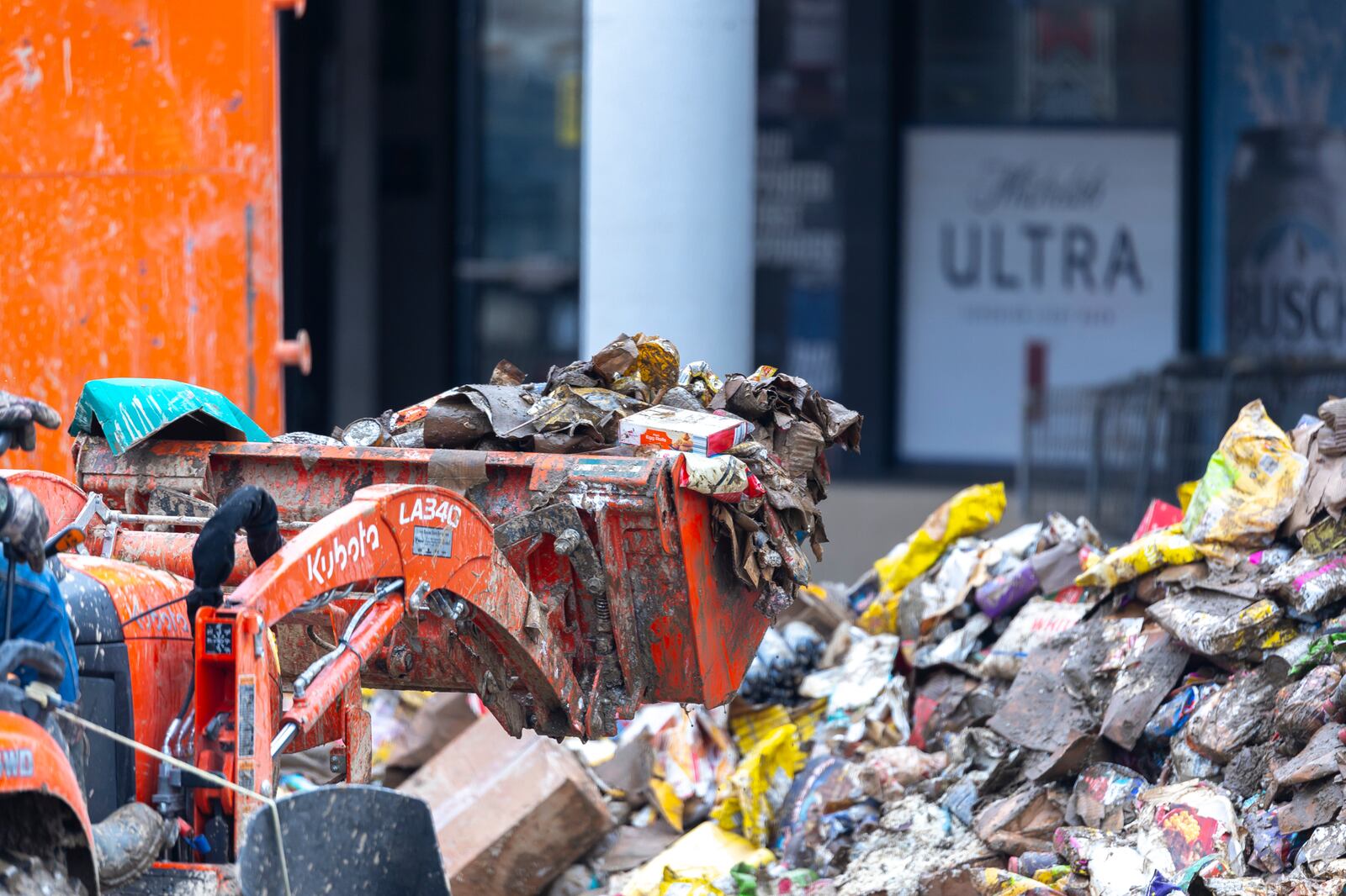 A person clears spoiled groceries and debris from a Save A Lot in Pike County, Ky., Tuesday, Feb. 18, 2025, after a storm the previous weekend. (Ryan C. Hermens/Lexington Herald-Leader via AP)