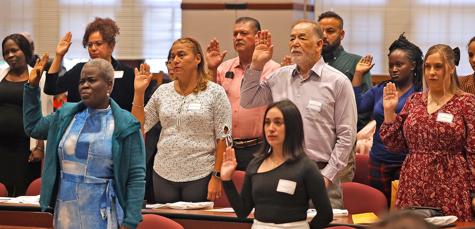 People from all over the world are sworn-in as American citizens Monday, Sept. 18, 2023 during a naturalization ceremony at the University of Dayton School of Law. BILL LACKEY/STAFF