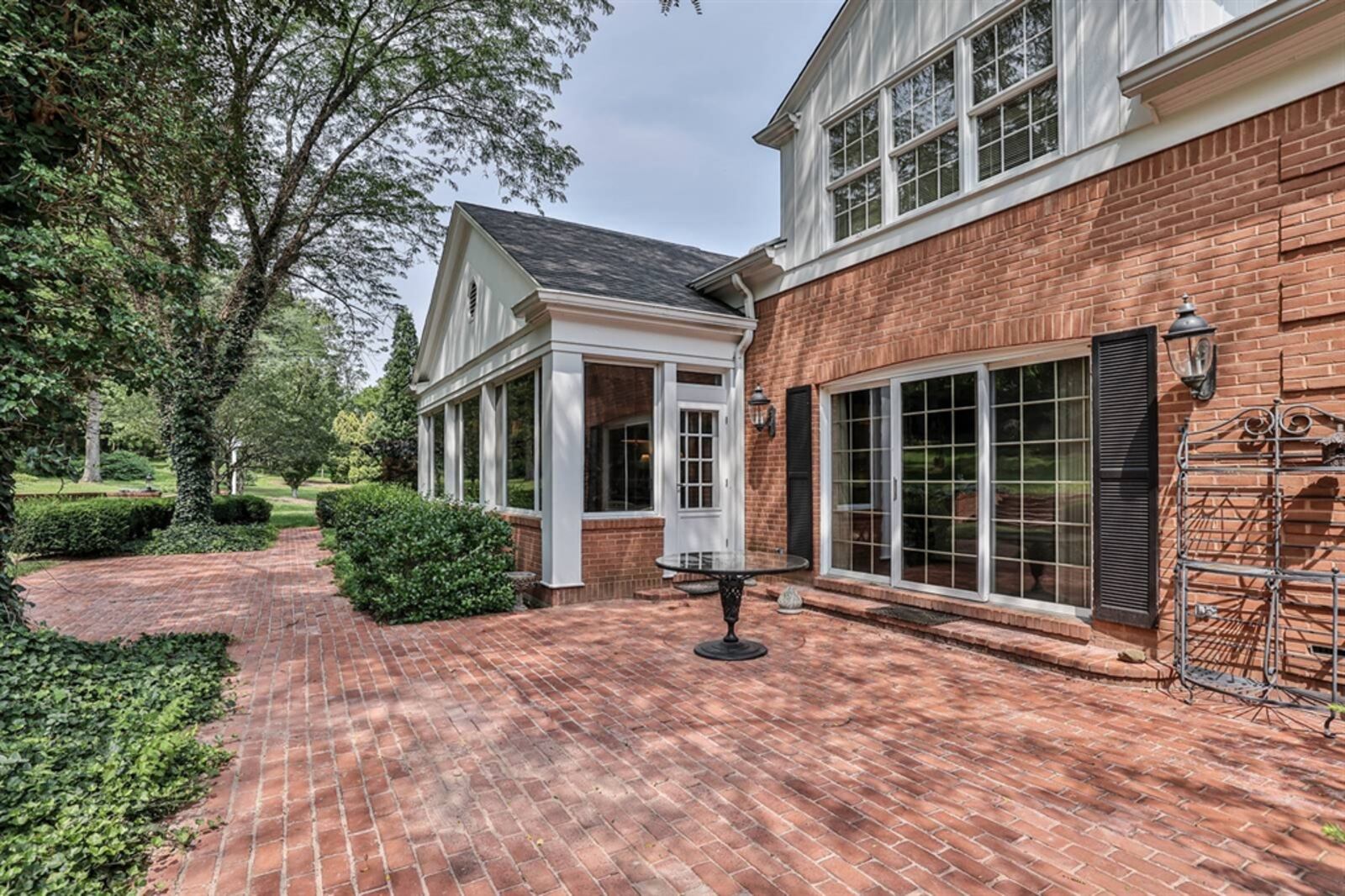 A large patio extends across the back and has views of the terraced garden and arboretum. Contributed