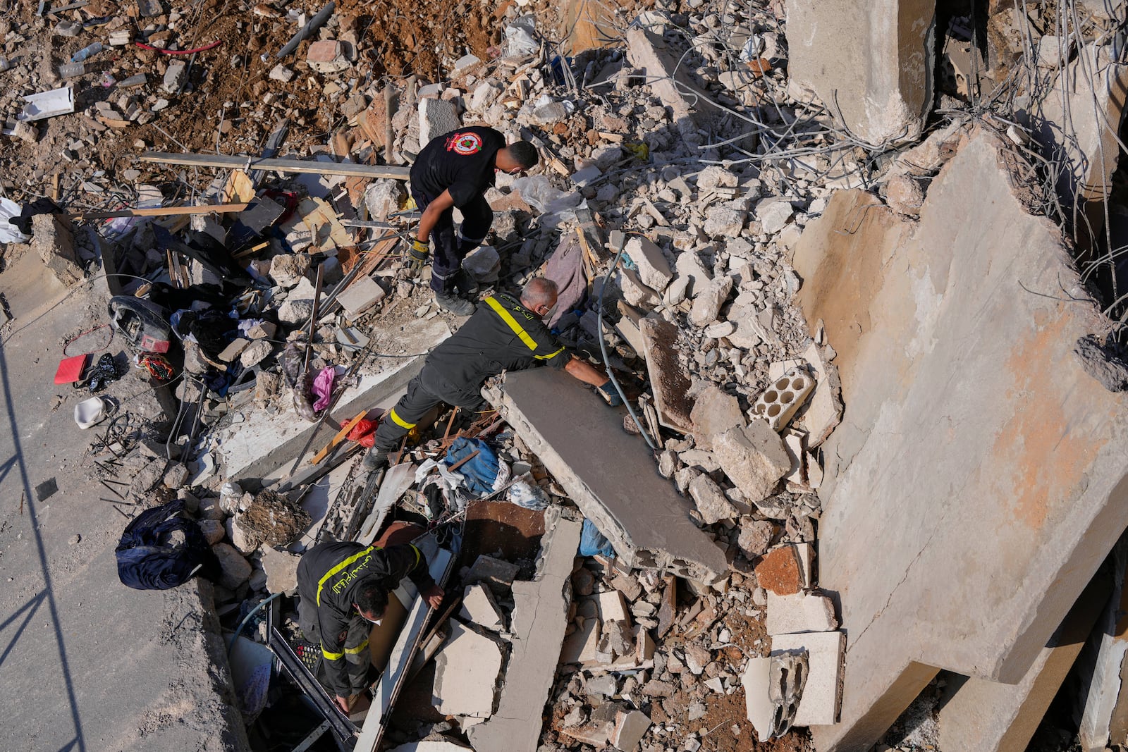 Civil defense workers search for victims in the rubble of a destroyed building hit in an Israeli airstrike on Tuesday night, in Barja, Lebanon, Wednesday, Nov. 6, 2024. (AP Photo/Hassan Ammar)