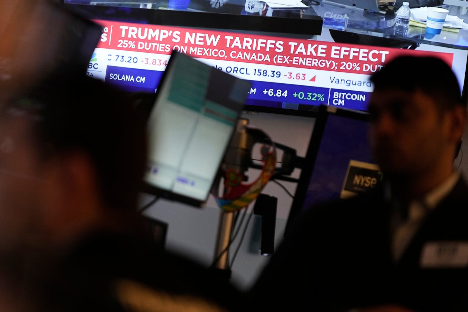 People work on the floor at the New York Stock Exchange in New York, Tuesday, March 4, 2025. (AP Photo/Seth Wenig)