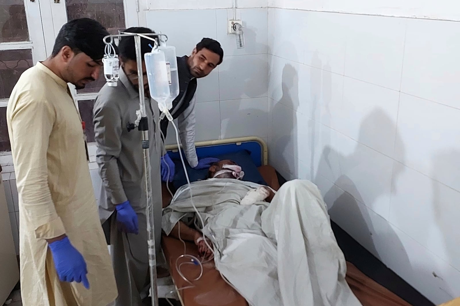 An injured victim of gunmen firing incident on passenger vehicles, is treated at a hospital in Parachinar, in Kurram district of Pakistan's northwestern Khyber Pakhtunkhwa province, Thursday, Nov. 21, 2024. (AP Photo/Dilawar Hussain)