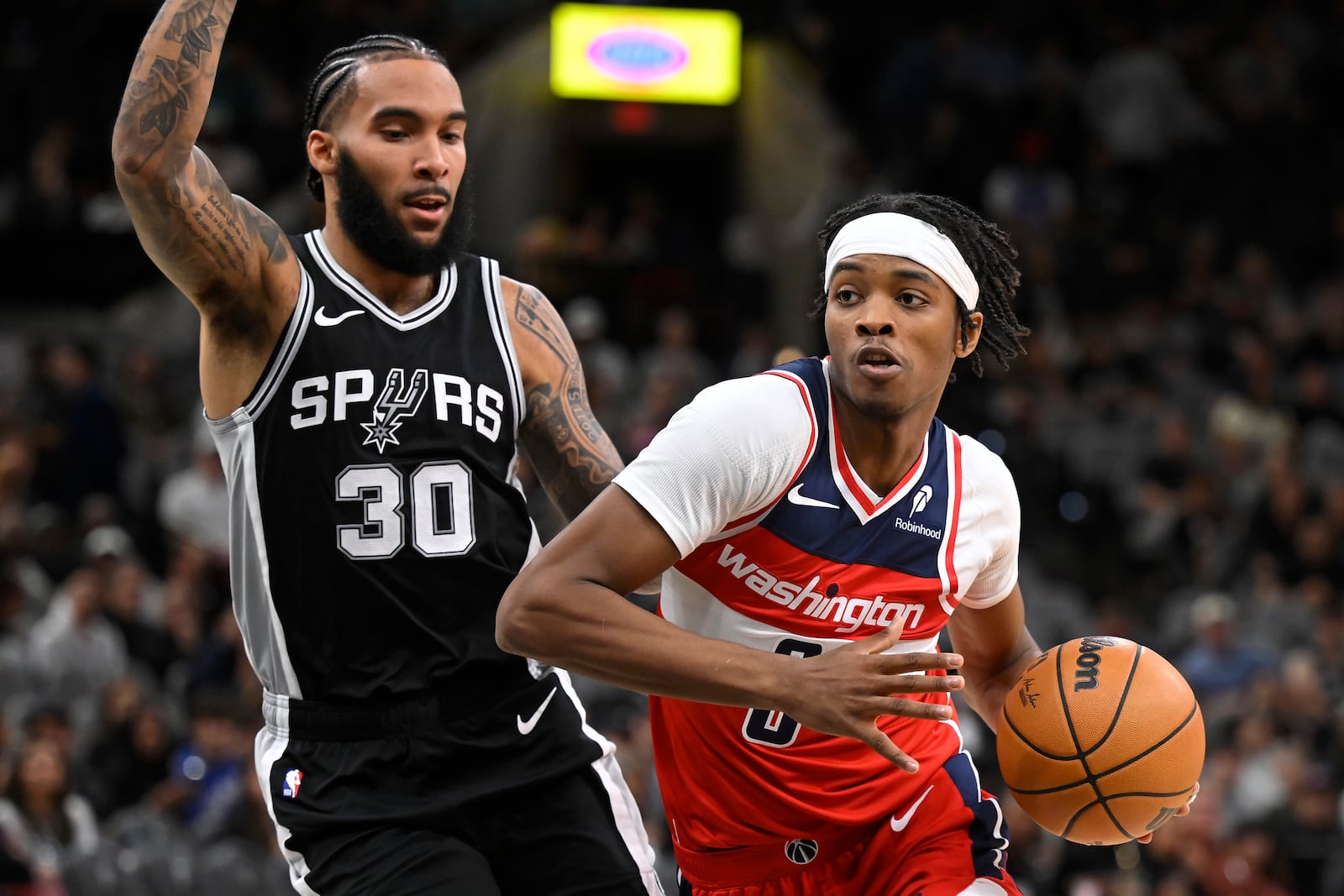 Washington Wizards' Bilal Coulibaly, right, drives against San Antonio Spurs' Julian Champagnie during the first half of an NBA basketball game, Thursday, Nov. 13, 2024, in San Antonio. (AP Photo/Darren Abate)