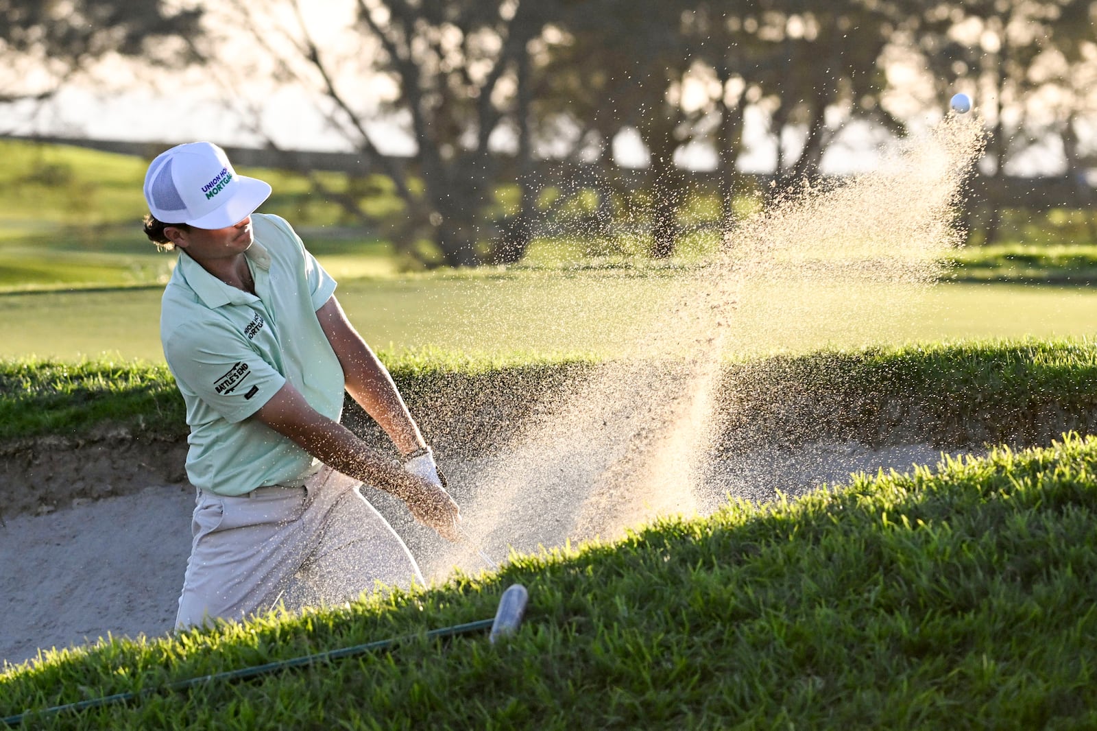 Luke Clanton hits out of a bunker on the 14th hole of the South Course at Torrey Pines during the second round of the Farmers Insurance Open golf tournament Thursday, Jan. 23, 2025, in San Diego. (AP Photo/Denis Poroy)