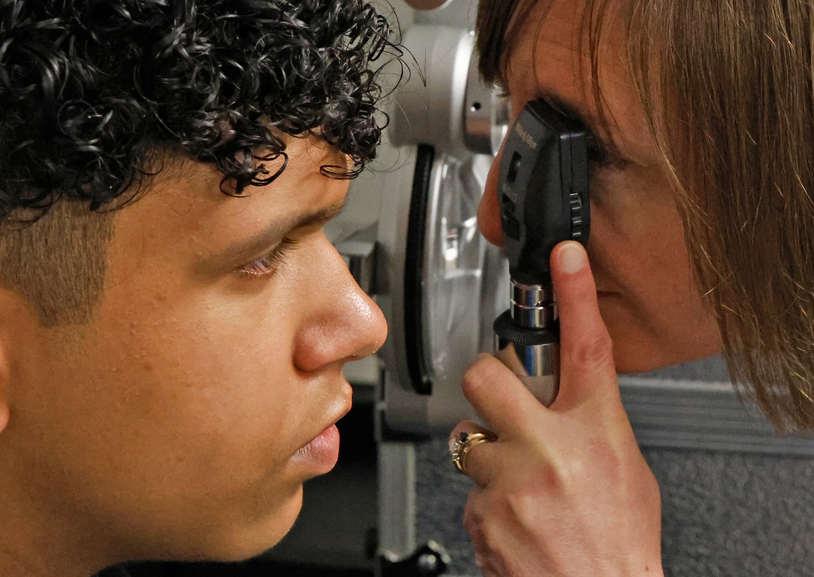 Southeastern eighth grader Eddie Jones gets his eyes examined by Dr. Lindsay Florkey at Miami View School Friday, April 12, 2024. The Ohio Optometric Association held an In-School Eye Exam (iSEE) event at Miami View School. The iSEE program is operated by the Ohio Optometric Foundation (OOF) and provides comprehensive eye exams to students identified by school nurses as needing vision care. The students then get to pick out and are fitted for glasses that they receive at no charge. BILL LACKEY/STAFF