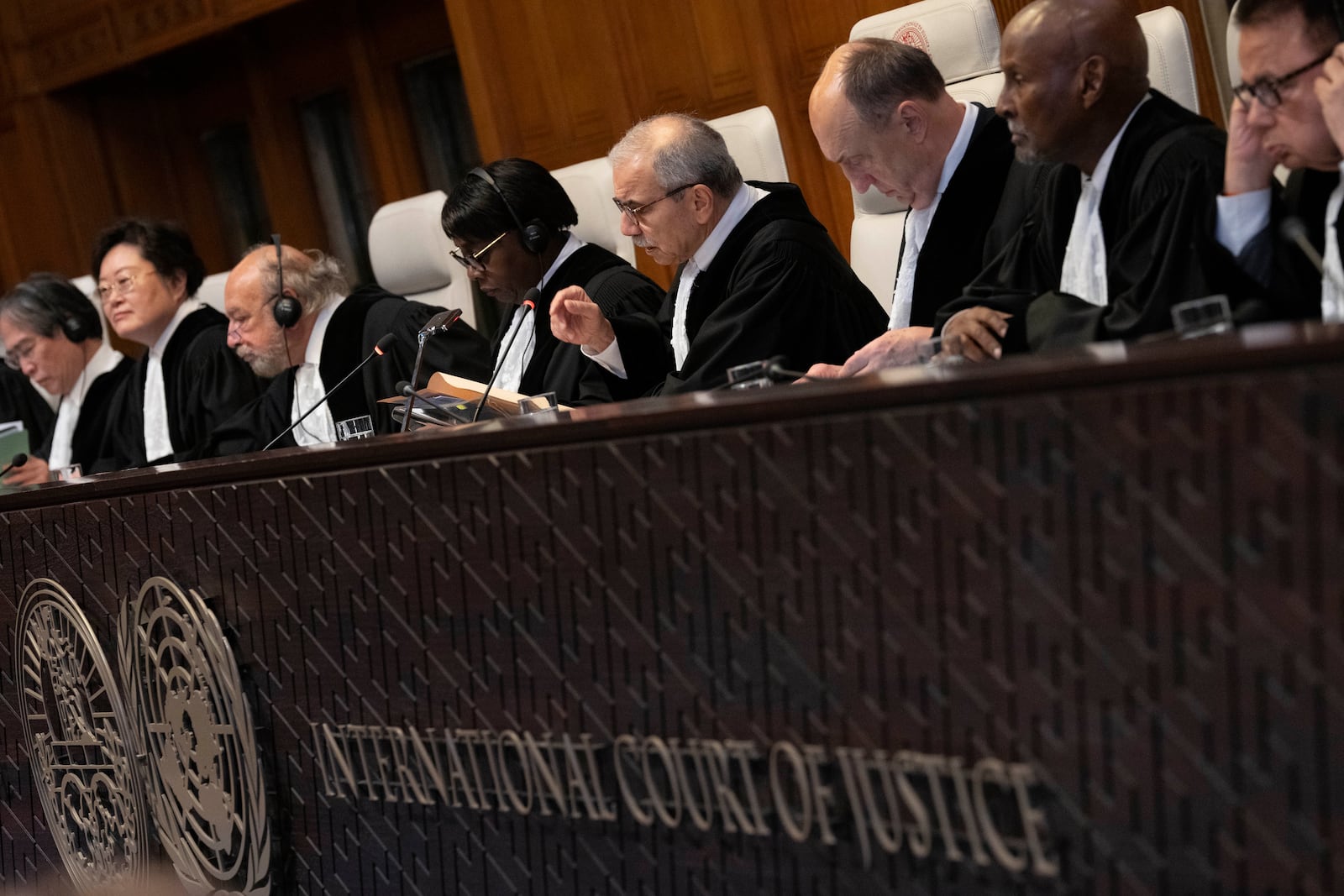 Presiding Judge Nawaf Salam, gestures as the International Court of Justice in The Hague, Netherlands, opens hearings into what countries worldwide are legally required to do to combat climate change and help vulnerable nations fight its devastating impact, Monday, Dec. 2, 2024. (AP Photo/Peter Dejong)