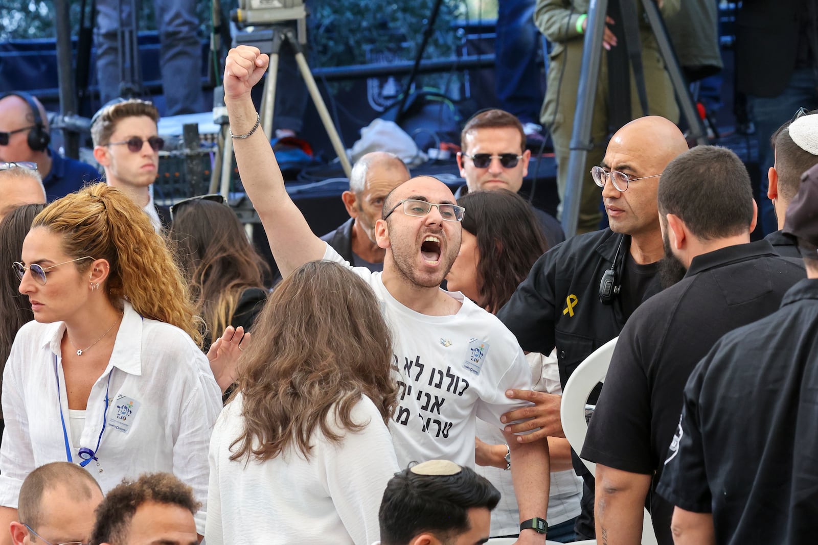 A man shouts as Israeli Prime Minister Benjamin Netanyahu speaks during a ceremony marking the Hebrew calendar anniversary of the Hamas attack on October 7 last year, at the Mount Herzl military cemetery in Jerusalem, Israel Sunday Oct. 27, 2024. (Gil Cohen-Magen/Pool Photo via AP)