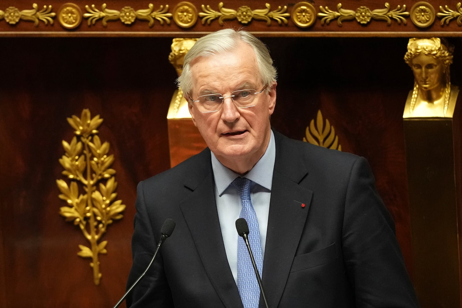 French Prime Minister Michel Barnier addresses the National Assembly prior to a vote on a no-confidence motion that could bring him down and his cabinet for the first time since 1962, Wednesday, Dec. 4, 2024 in Paris. (AP Photo/Michel Euler)