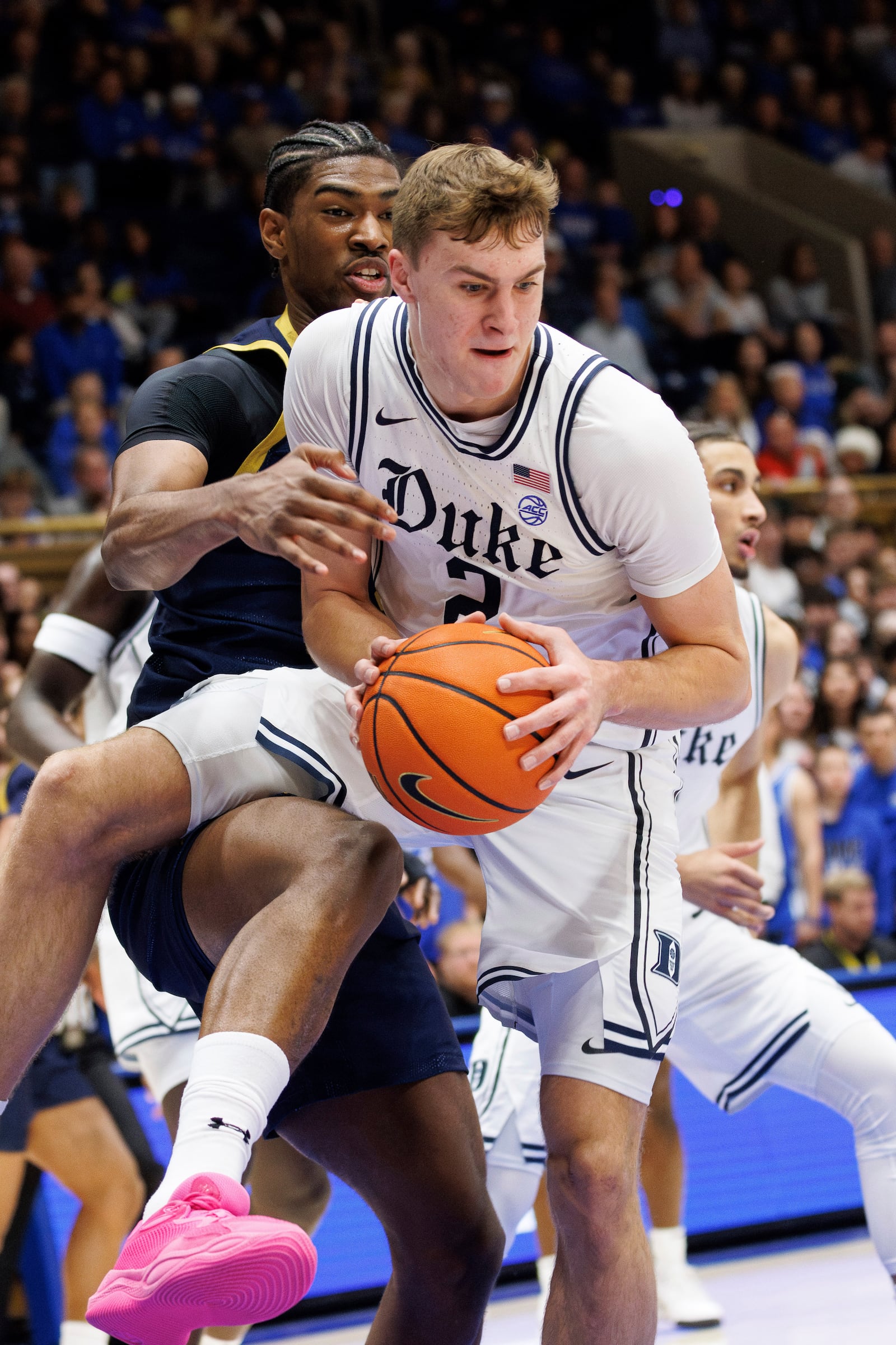 Duke's Cooper Flagg (2) grabs a rebound ahead of Notre Dame's Kebba Njie, left, during the first half of an NCAA college basketball game in Durham, N.C., Saturday, Jan. 11, 2025. (AP Photo/Ben McKeown)