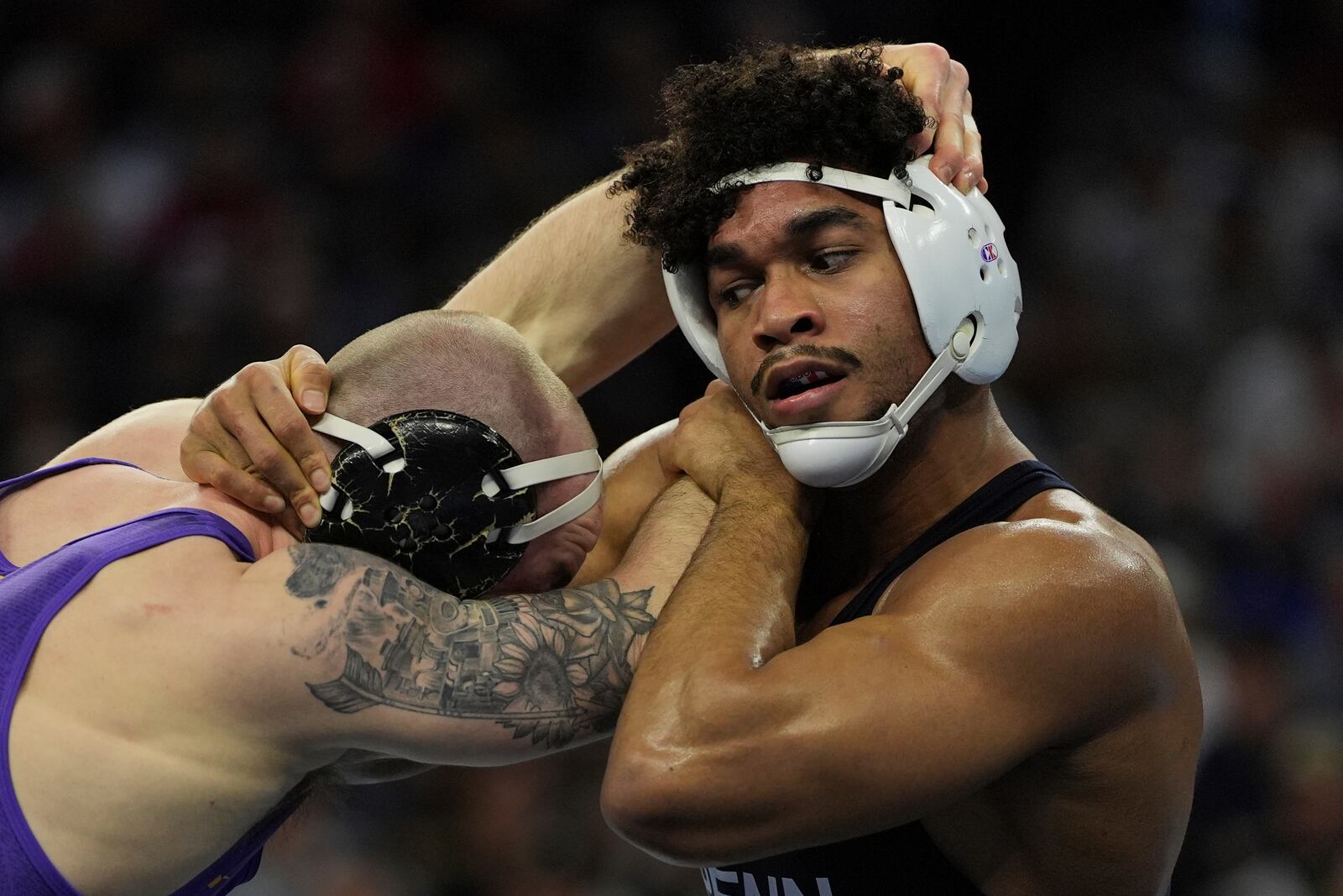 Penn State's Carter Starocci, right, takes on Northern Iowa's Parker Keckeisen during a 184-pound match in the finals at the NCAA wrestling championship, Saturday, March 22, 2025, in Philadelphia. (AP Photo/Matt Rourke)