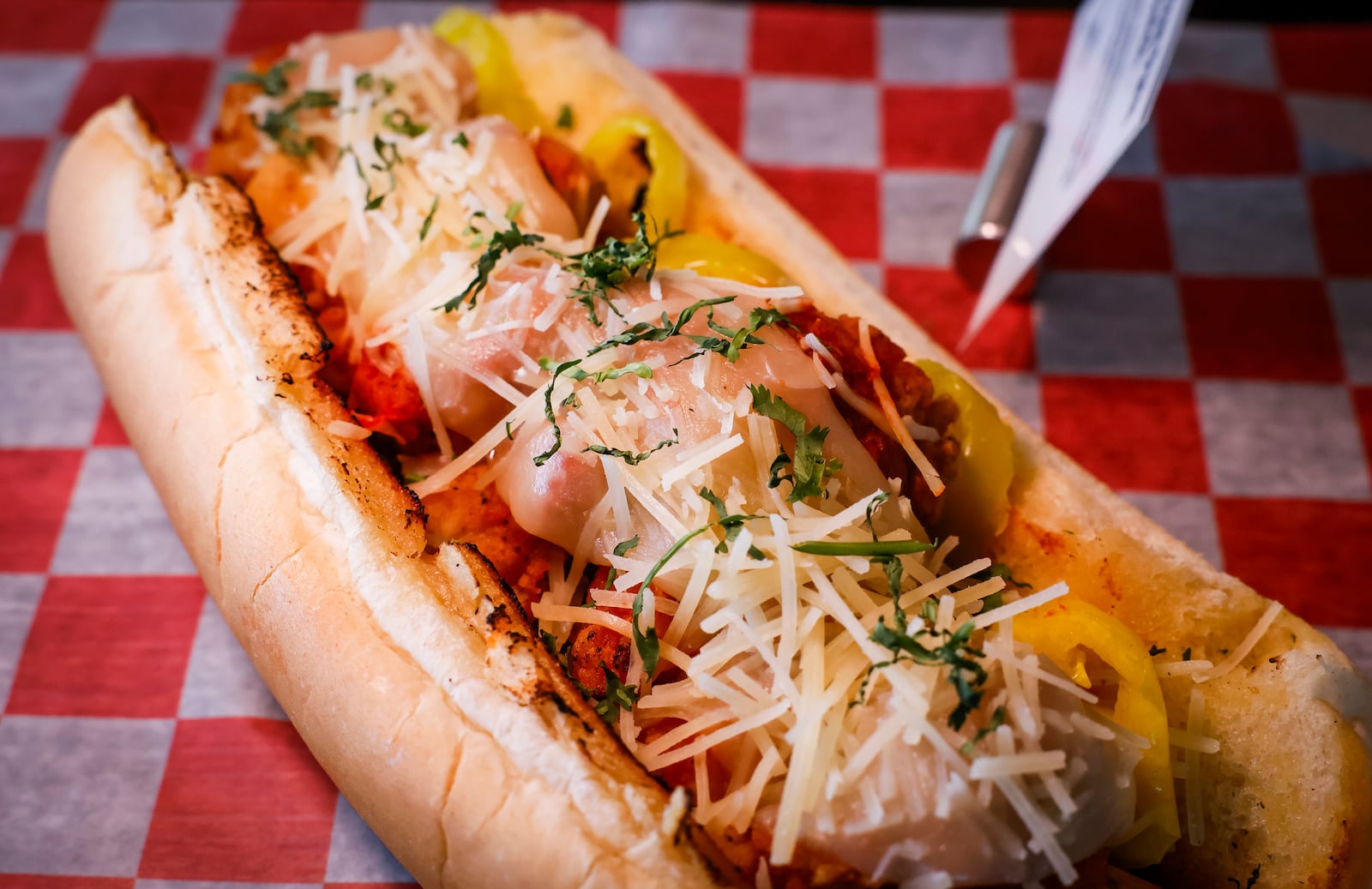 The Cincinnati Reds announced new menu items ahead of opening day on Friday, March 21, 2025 in The Handlebar at the Riverfront Club inside Great American Ball Park in Cincinnati. Executive Chef Gary Davis created a variety of new dishes for the upcoming season. This is the Bigg Mozz Chicken Parm Sandwich with crispy checken tender, big mozz sticks, provolone cheese, marinara sauce and banana peppers on hoagie bun. NICK GRAHAM/STAFF