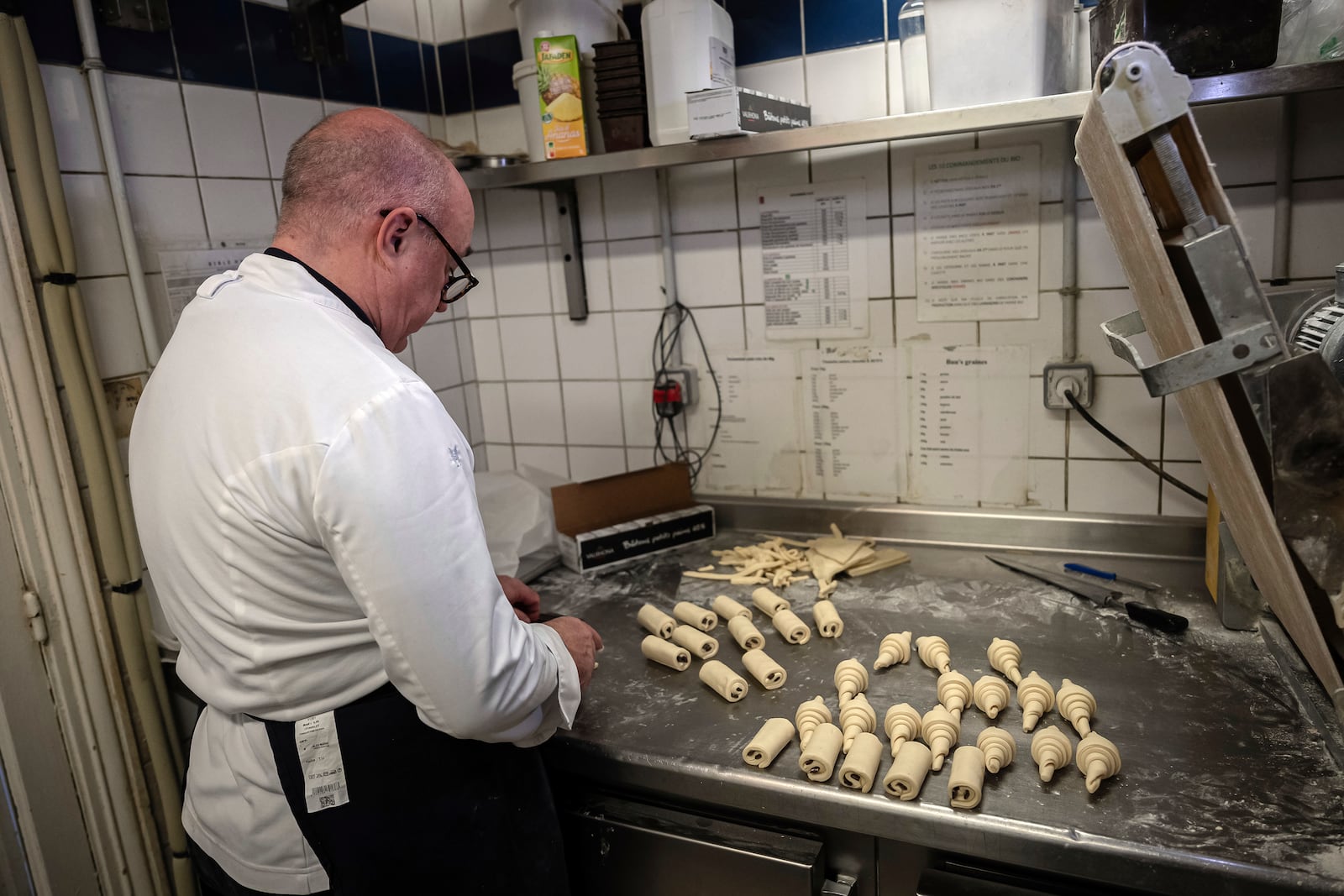 French baker Arnaud Delmontel bakes butter croissants and "pains au chocolat" in his bakery in Paris, Monday, Dec. 16, 2024 as butter has shot up in price across Europe in recent months, adding more pain to consumers this holiday season after years of inflation in the wake of the COVID-19 pandemic and war in Ukraine.(AP Photo/Aurelien Morissard)