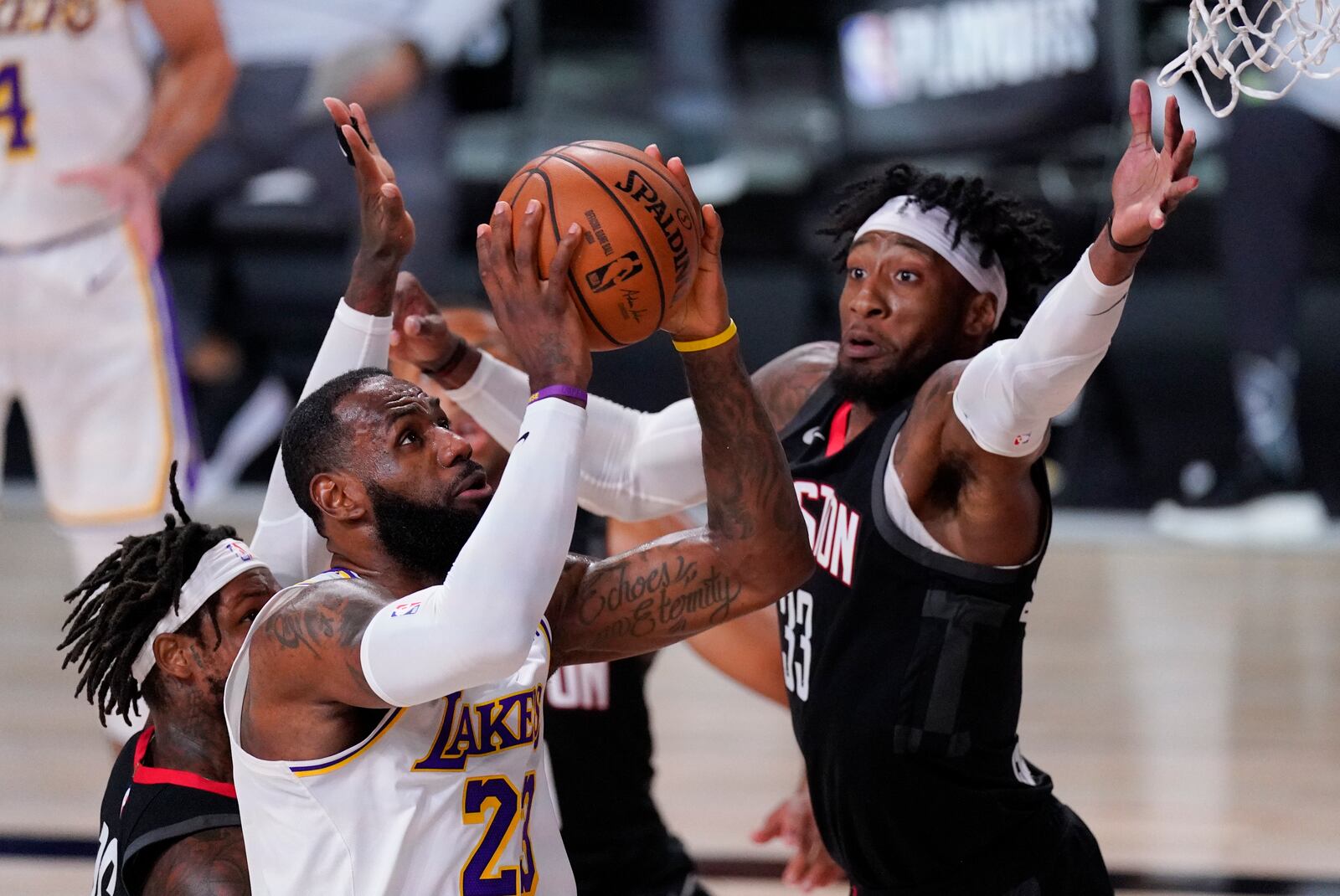 Los Angeles Lakers' LeBron James (23) drives to the basket past Houston Rockets' Robert Covington (33) during the first half of an NBA conference semifinal playoff basketball game Tuesday, Sept. 8, 2020, in Lake Buena Vista, Fla. (AP Photo/Mark J. Terrill)