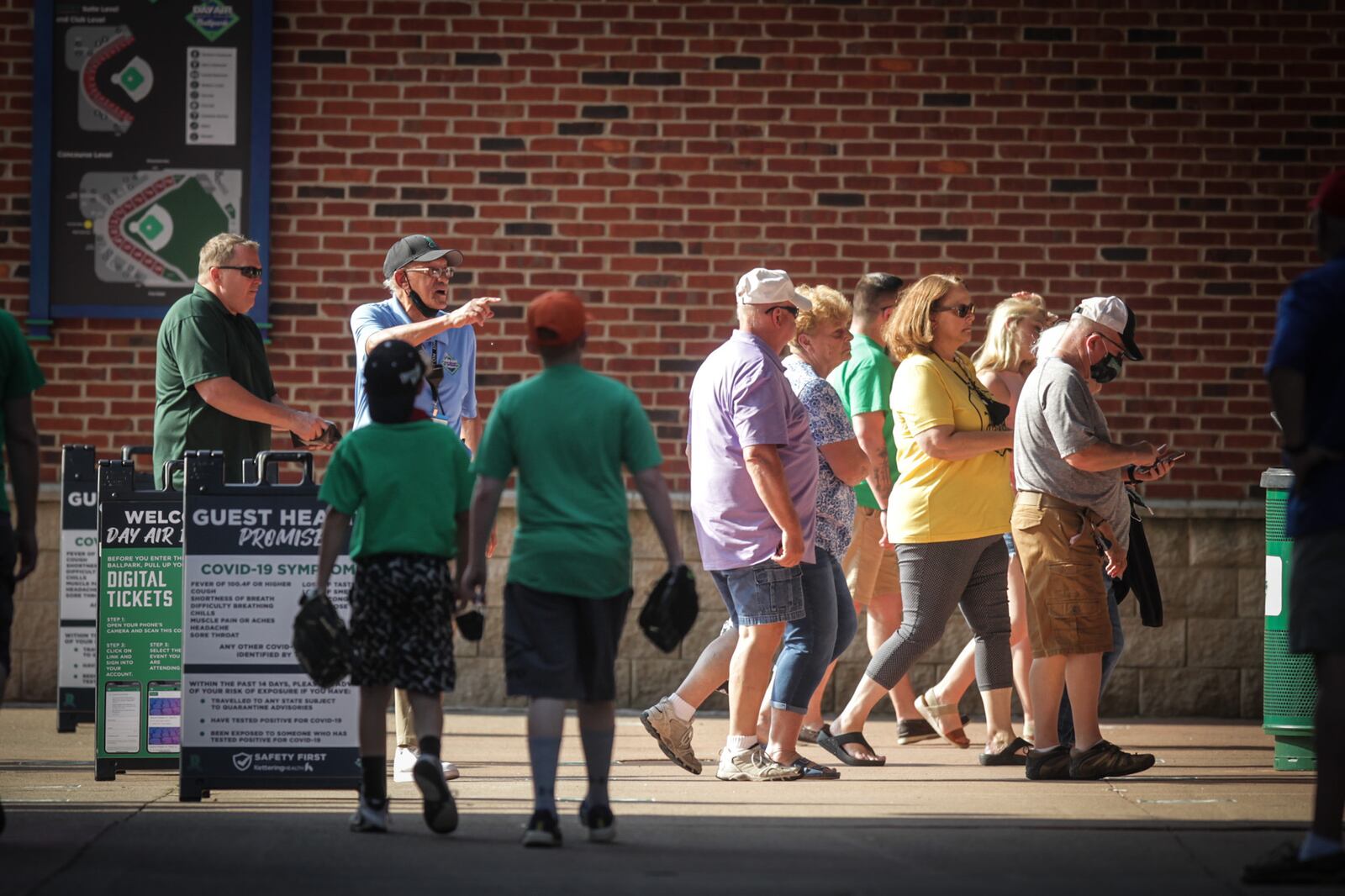 Dragons fans enter the ballpark Tuesday evening, May 25, 2021, after spending some time in the hot spring sun. It was the warmest day of the year so far with the high temperature reported at 88 degrees in Dayton and Cincinnati, which is more than 10 degrees above normal. JIM NOELKER / STAFF