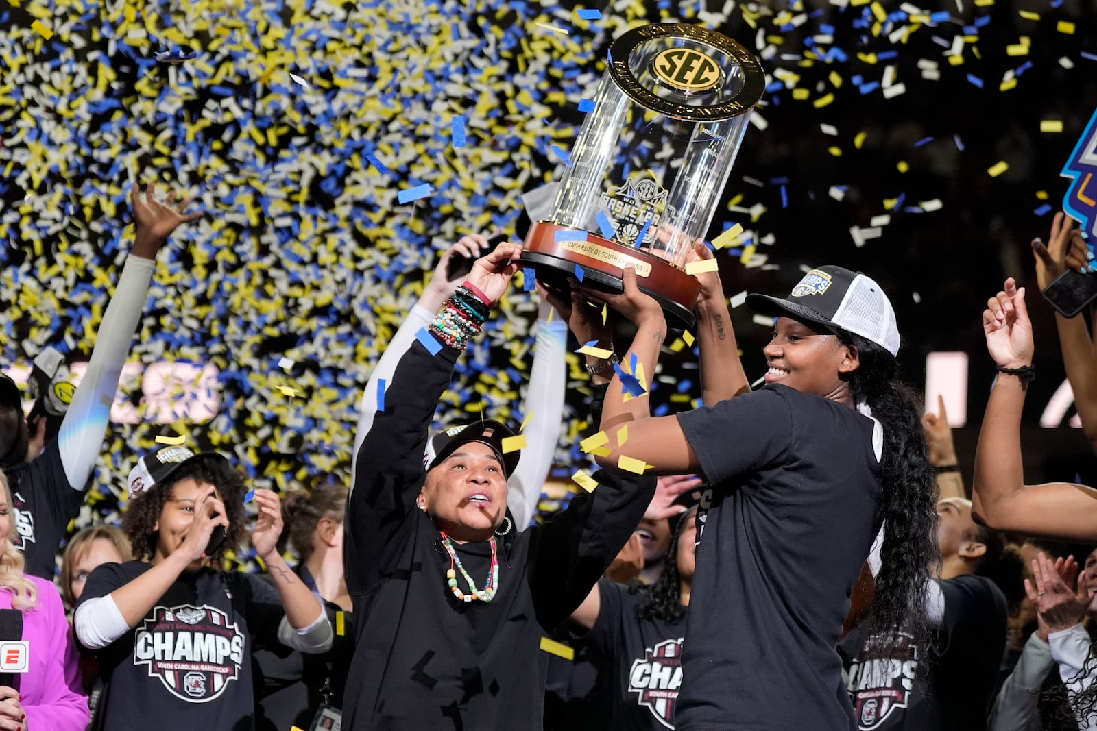 South Carolina head coach Dawn Staley holds the trophy with guard Bree Hall after their win against Texas in an NCAA college basketball game in the final of the Southeastern Conference tournament, Sunday, March 9, 2025, in Greenville, S.C. (AP Photo/Chris Carlson)