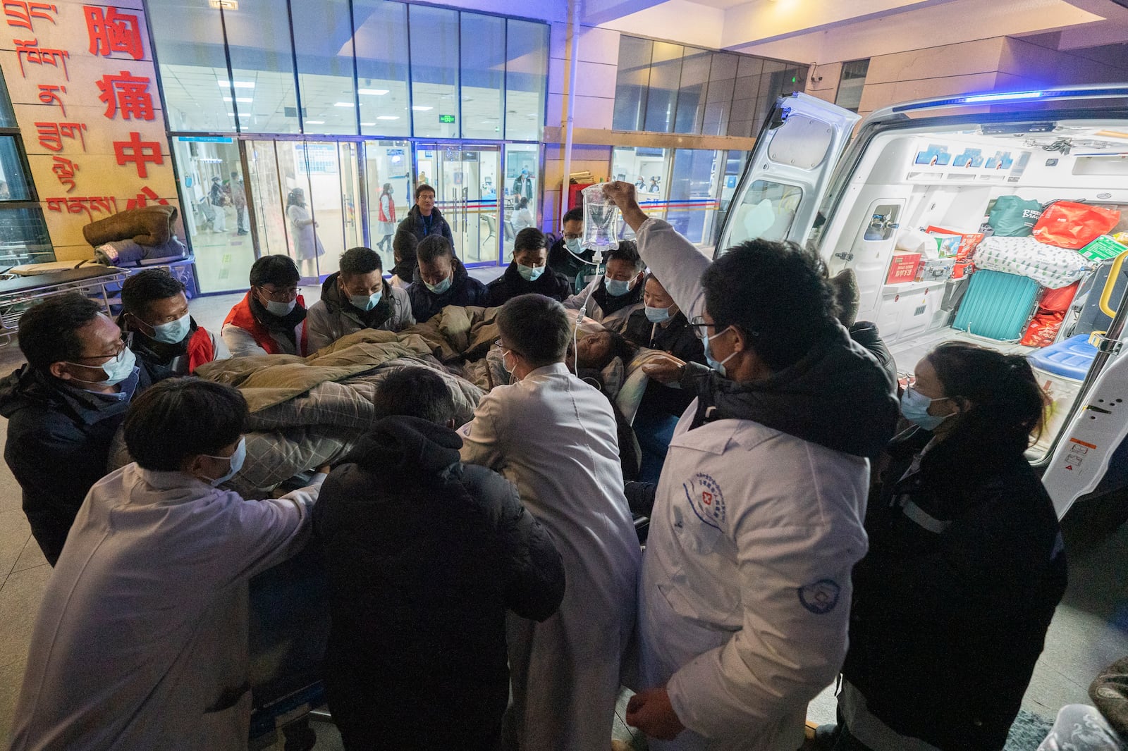 In this photo released by Xinhua News Agency, medical workers transfer an injured resident to the emergency room in the aftermath of an earthquake at the Xigaze People's Hospital in Xigaze City, southwest China's Tibet Autonomous Region, Wednesday Jan. 8, 2025. (Tenzin Nyida/Xinhua via AP)