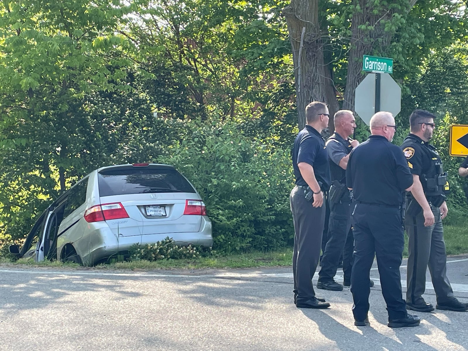 Springfield police and the Clark County Sheriff's Office investigate the scene at the intersection of Fairfield Pike and Garrison Road, where a minivan crashed Monday, May 22, 2023 while being pursued from Selma Road in Springfield. Three people reportedly were involved in the crash, and one of them was transported by medical helicopter. One was not injured and the third fled the scene and was later captured in a nearby field. A fourth individual jumped out of the car soon after the pursuit began. BILL LACKEY/STAFF