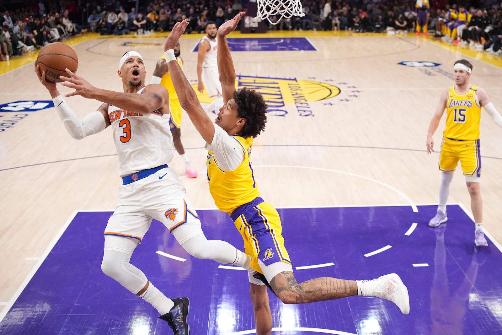 New York Knicks guard Josh Hart, left, shoots as Los Angeles Lakers center Jaxson Hayes defends during the first half of an NBA basketball game Thursday, March 6, 2025, in Los Angeles. (AP Photo/Mark J. Terrill)