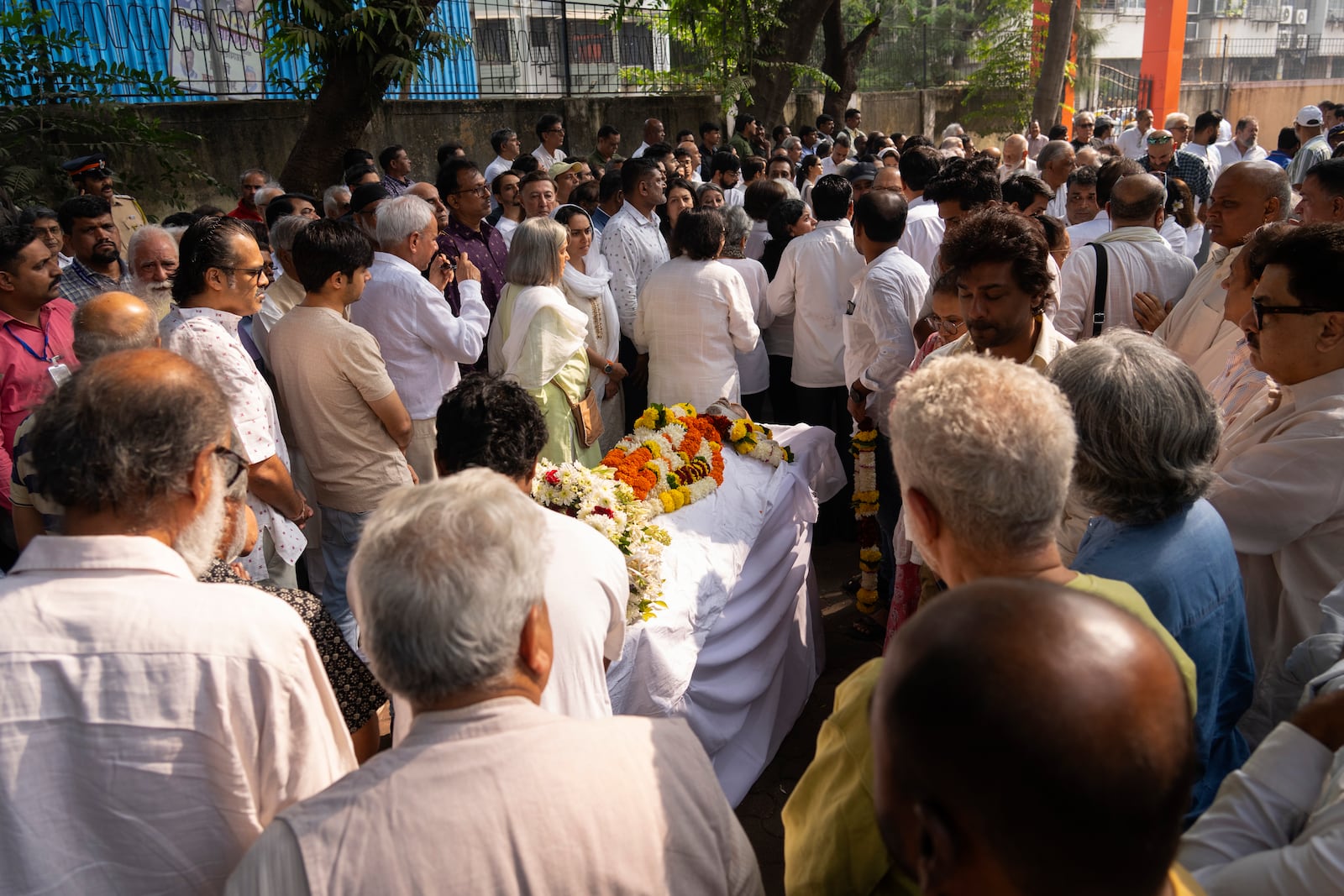 Friends and relatives pay homage to Shyam Benegal, a renowned Indian filmmaker who passed away on Monday, during Benegal's funeral in Mumbai, India, Tuesday, Dec. 24, 2024. (AP Photo/Rafiq Maqbool)